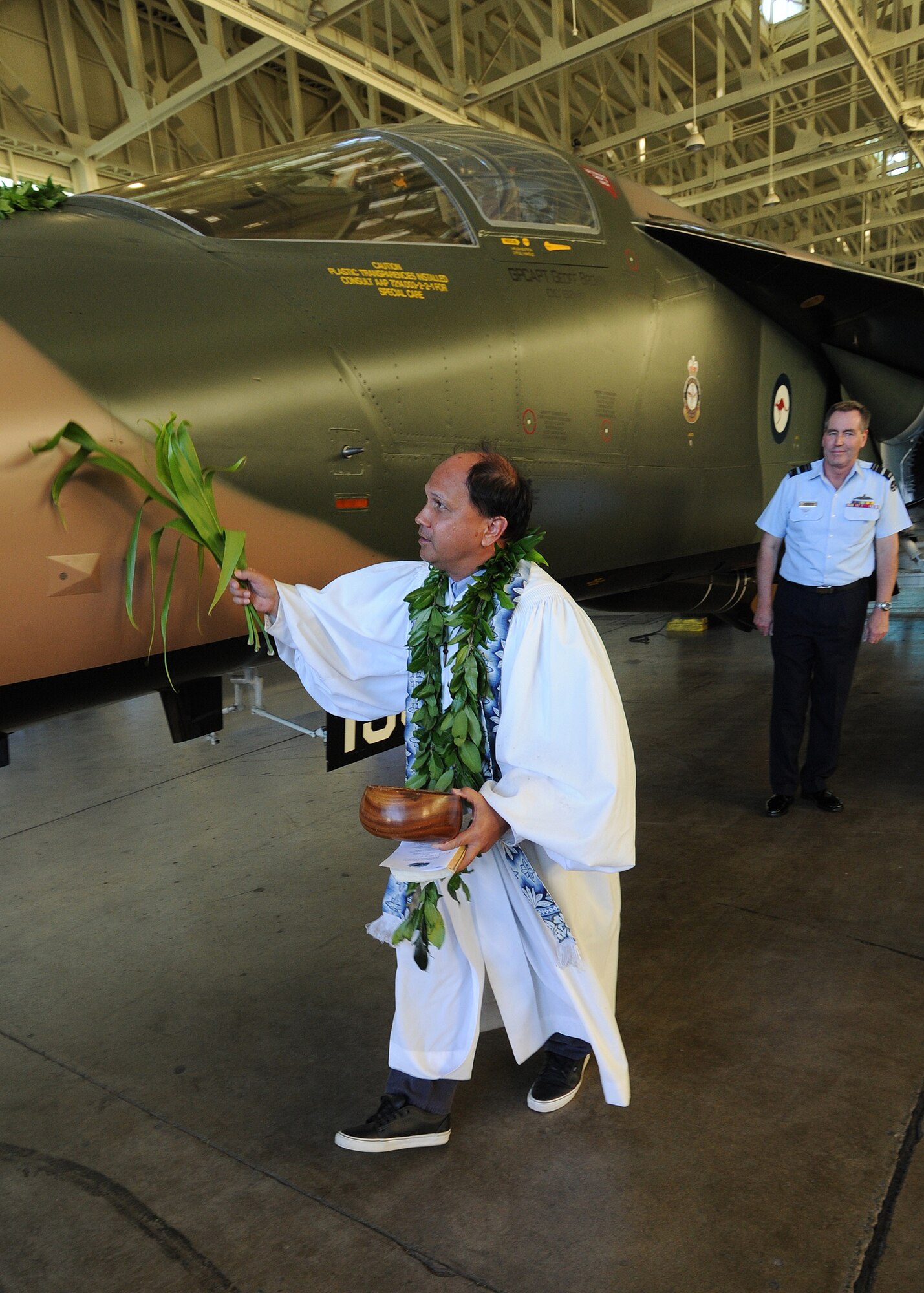 Kahu Kordell Kekoa blesses a Royal Australian Air Force F-111C with ti leaves and Hawaiian water during the F-111C dedication ceremony at the Pacific Aviation Museum, Ford Island, Hawaii, Nov. 23, 2013.  Pacific Air Forces maintains current and will hold future exercises involving Australian partners as part of an overall engagement plan.  Australia is a longstanding ally to the U.S. and their alliance is solidly grounded on shared values and common security concerns and approaches. The United States is committed to working with its friends and allies in the region, building partnership and maintaining peace and stability. (U.S. Air Force photo/Tech Sgt. Jerome S. Tayborn/Released)