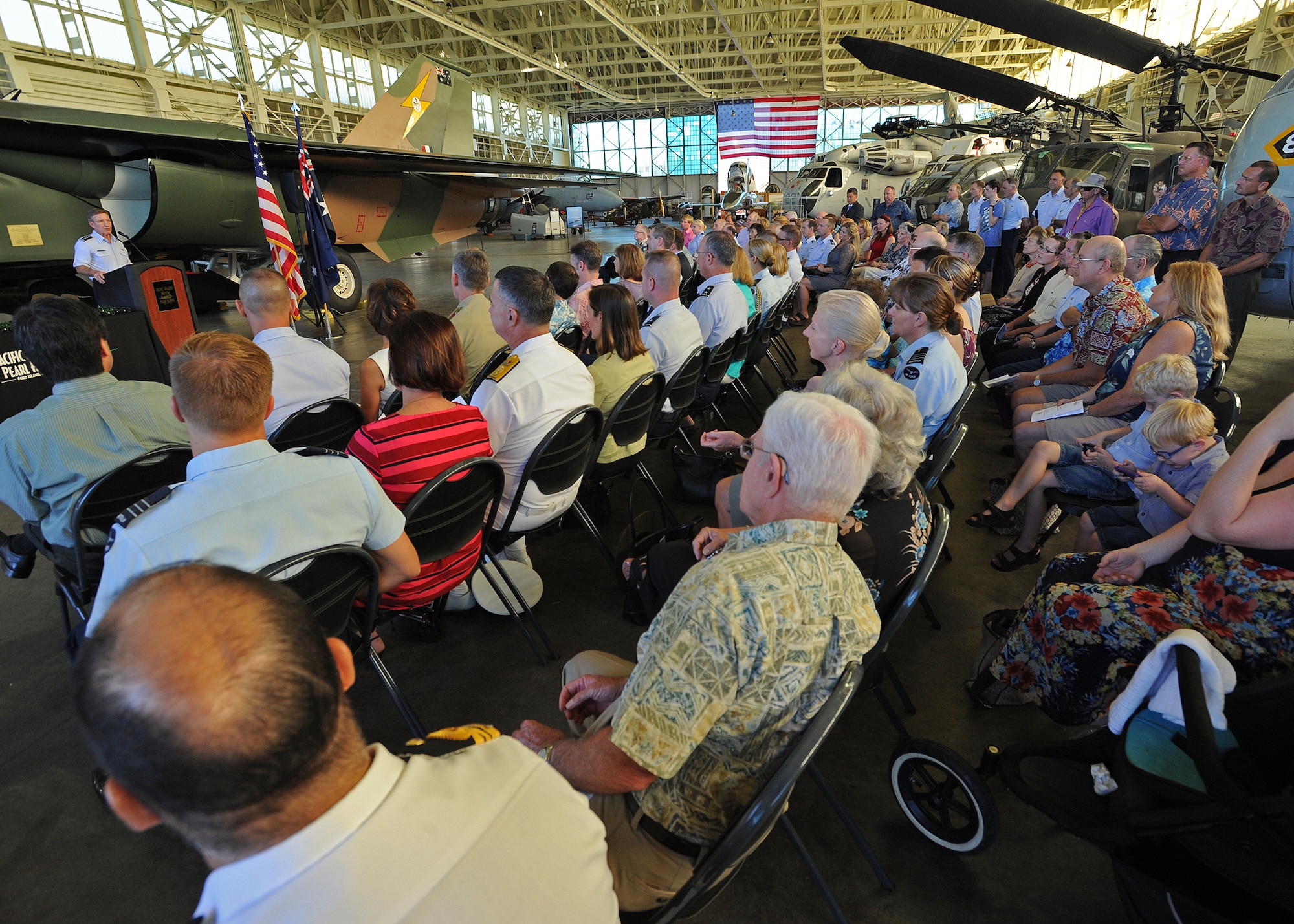 Attendees at the Pacific Air Museum’s dedication of a Royal Australian Air Force Air F-111C listen attentively to Gen. Hawk Carlisle, commander of Pacific Air Forces, at Ford Island, Hawaii, Nov. 23, 2013. The attendees included veterans, business and civic leaders, and U.S. military leaders. The F-111 was a tactical bomber, flying hundreds of miles close to earth and under radar, hitting target, and them zooming up high and dashing home at supersonic speed-all without refueling. Australian forces have fought beside the U.S. and other allies in every significant conflict since World War I. The United States Air Force and the Royal Australian Air Force share a long and distinguished history of cooperation.  (U.S. Air Force photo/Tech Sgt. Jerome S. Tayborn/Released)