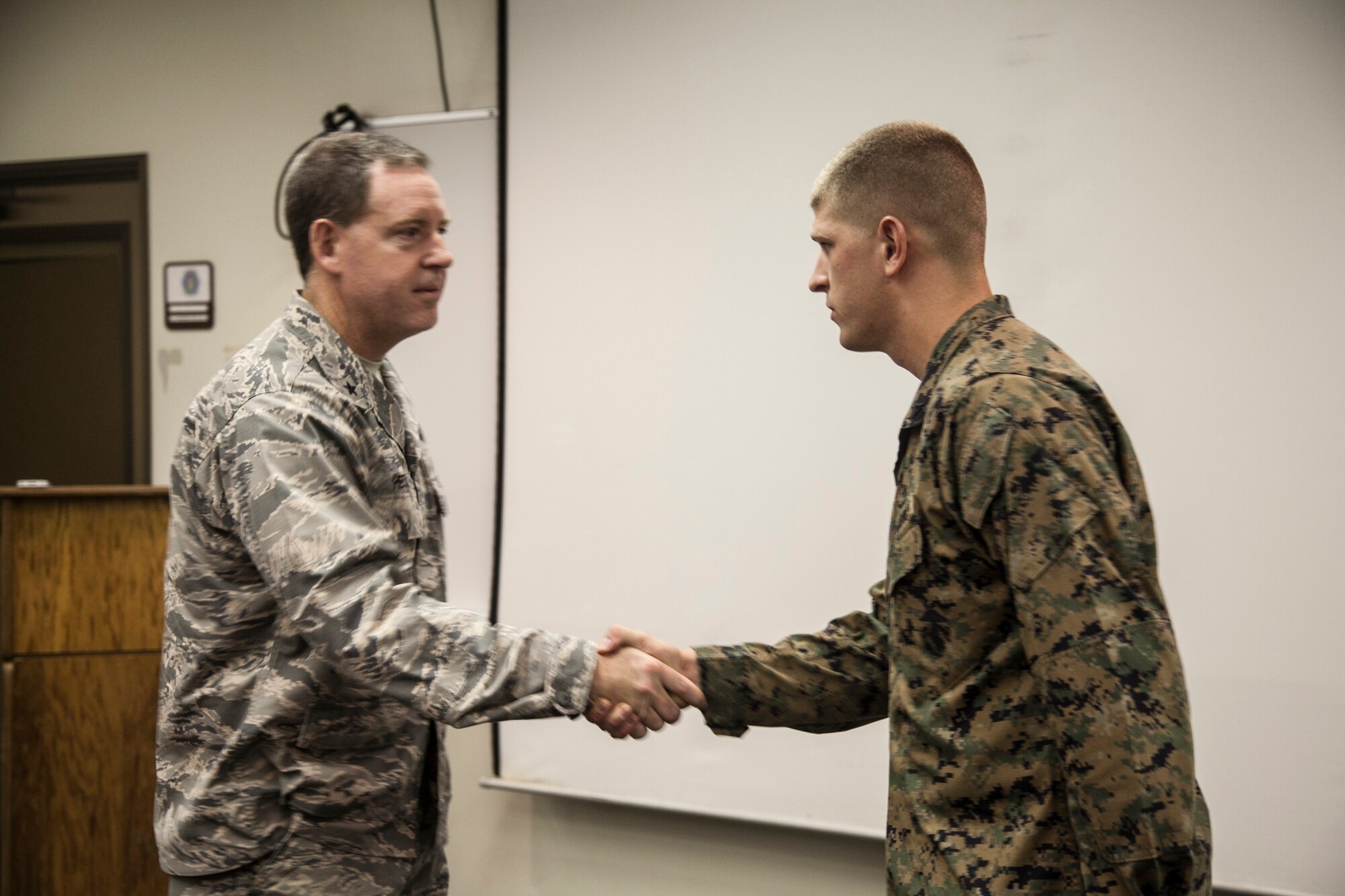 Brig. Gen. James B. Hecker, 18th Wing commander, speaks to Lance Cpl. Stosh K. Fernandez, Nov. 7, 2013, at Kadena Air Base, Japan. While running the Kadena Half Marathon, Fernandez performed CPR on a community member and carried him to an ambulance. Fernandez is an expeditionary air field technician with Marine Wing Support Squadron 172, Marine Aircraft Group 36, 1st Marine Aircraft Wing, III Marine Expeditionary Force. (U.S. Marine photo by Lance Cpl. Anne K. Henry)
