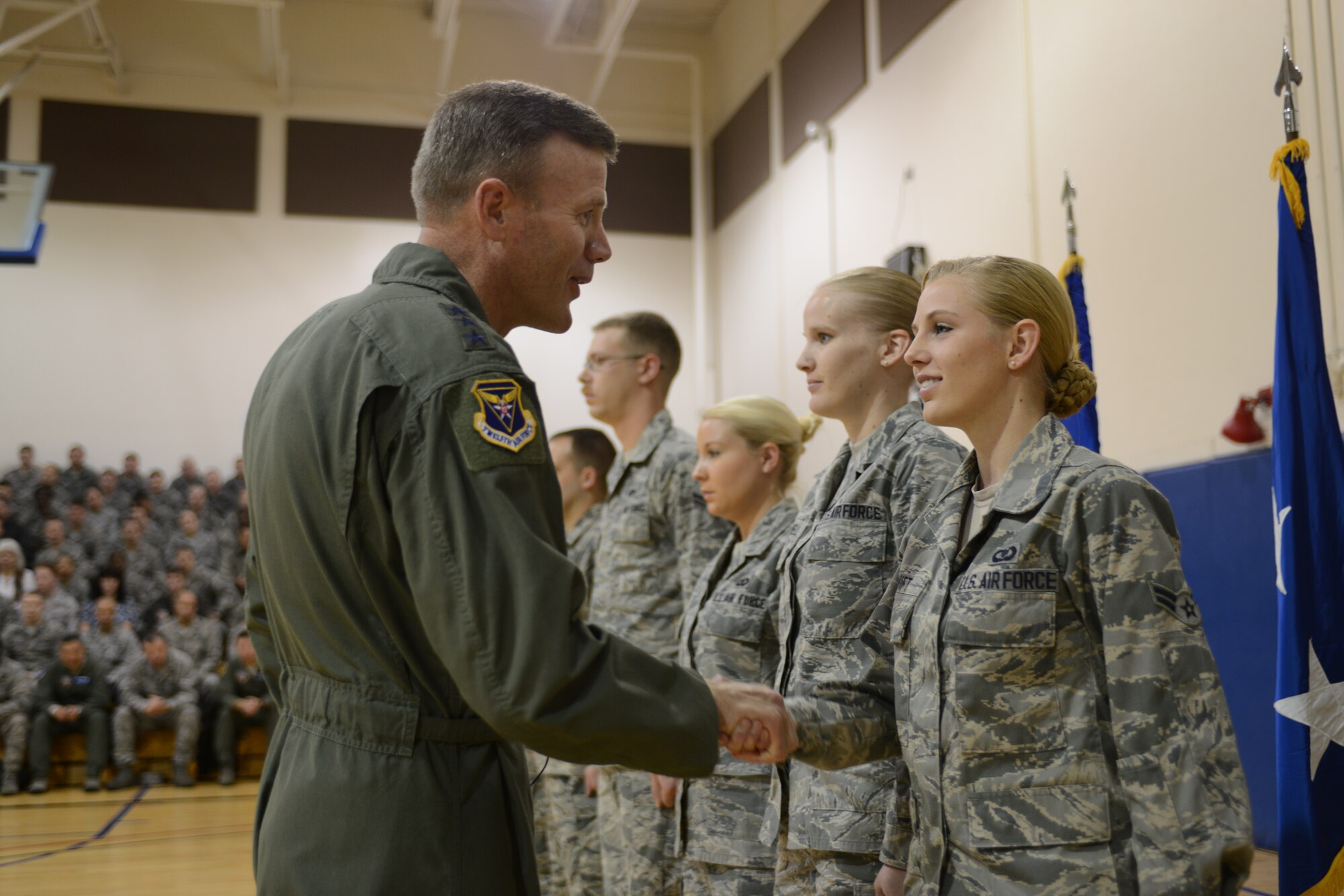 U.S. Air Force Lt. Gen. Tod Wolters, 12th Air Force (Air Forces Southern) commander, shakes hands with Airman 1st Class Gabrielle Swift, 366th Operations Support Squadron airfield management operations coordinator, Nov. 20, 2013, at Mountain Home Air Force Base, Idaho. General Wolters coined Swift for preventing a potential sexual assault at a Boise State University football game in October. (U.S. Air Force photo by Senior Airman Benjamin Sutton/Released)
