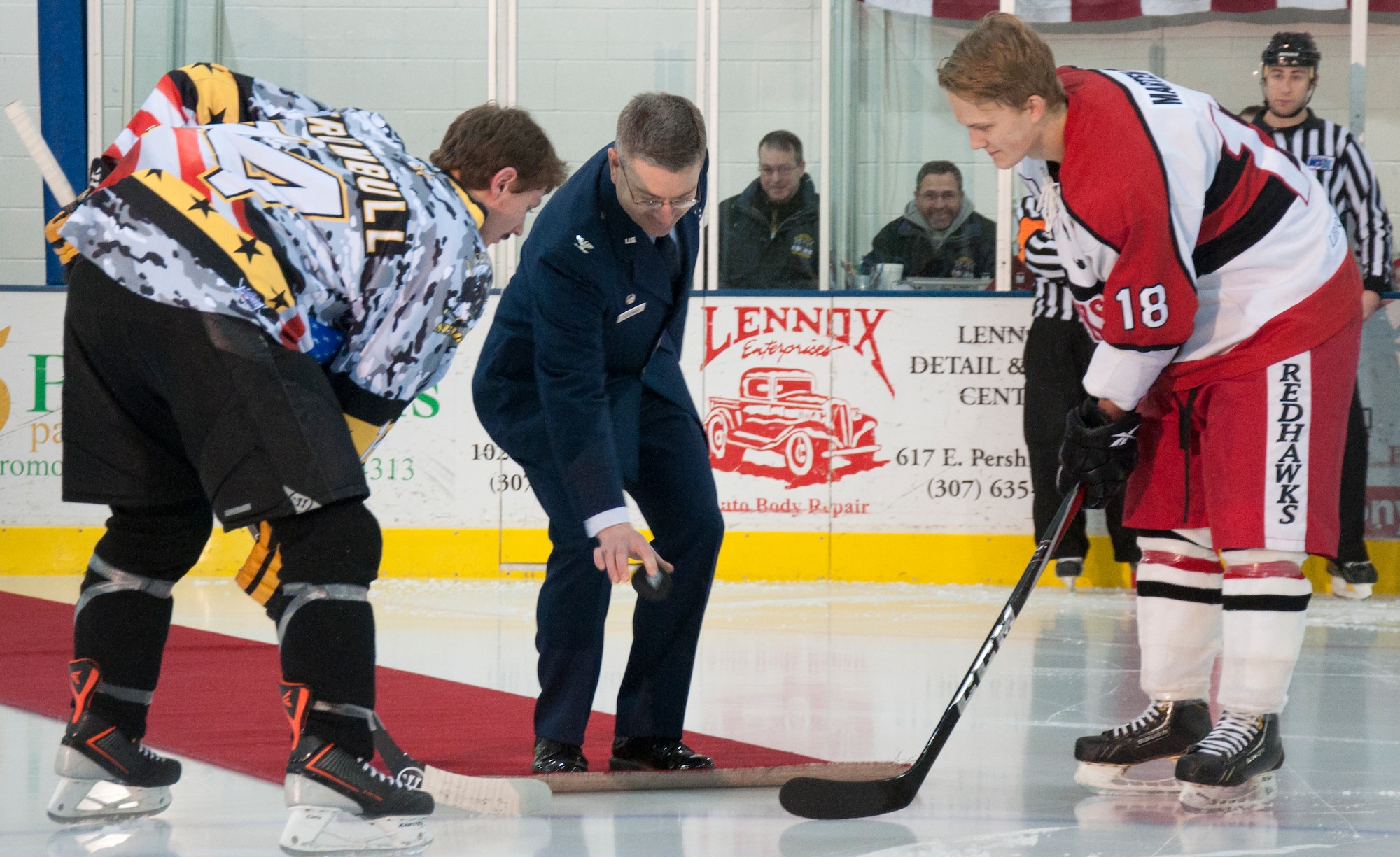 Col. Hans Ritschard, 90th Medical Group commander, performs the ceremonial puck drop for a game between the Cheyenne Stampede and the Arizona Redhawks Nov. 22, 2013. Ritschard performed the puck drop during the Stampede's military appreciation week. (U.S. Air Force photo by Airman 1st Class Brandon Valle)