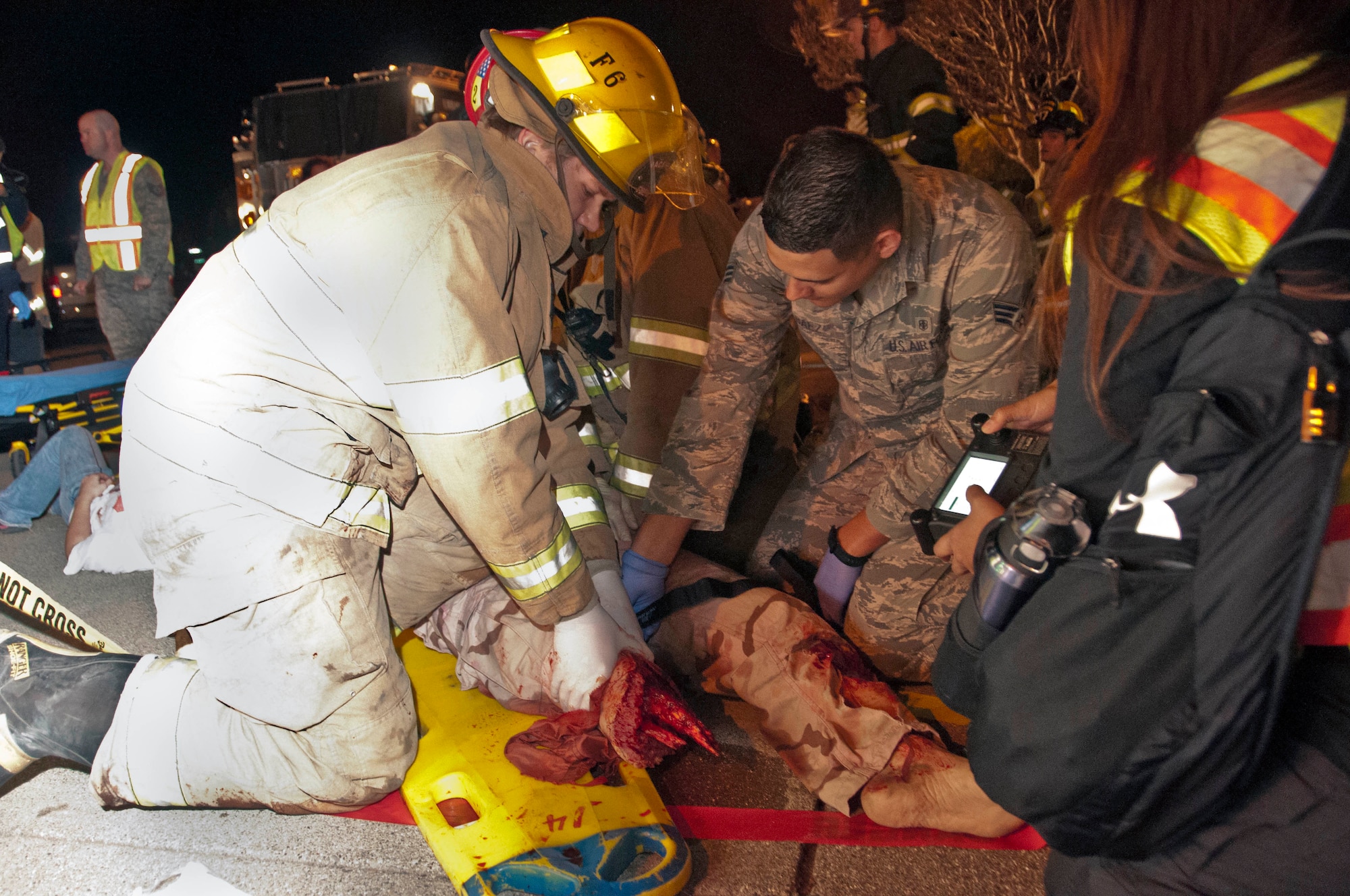 Travis Airmen and Solano County fire fighters work together to stop the arterial bleeding in the trauma mannequin Nov. 14 at the Sierra Vista Elementary School in Vacaville, Calif. during an exercise involving a school shooter. (U.S. Air Force photo/Senior Airman Madelyn Brown)
