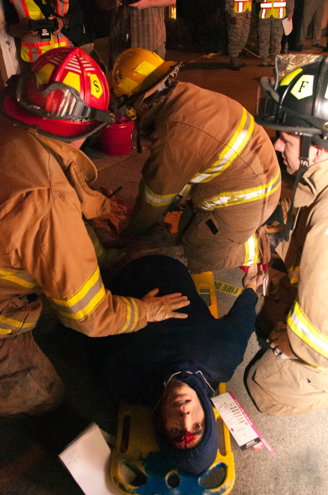 Fire fighters from different cities in Solano County collaborate to provide first aid to the trauma mannequin provided by David Grant USAF Medical Center in an exercise involving a school shooting at Sierra Vista Elementary in Vacaville, Calif. Nov. 14. (U.S. Air Force photo/Senior Airman Madelyn Brown)

