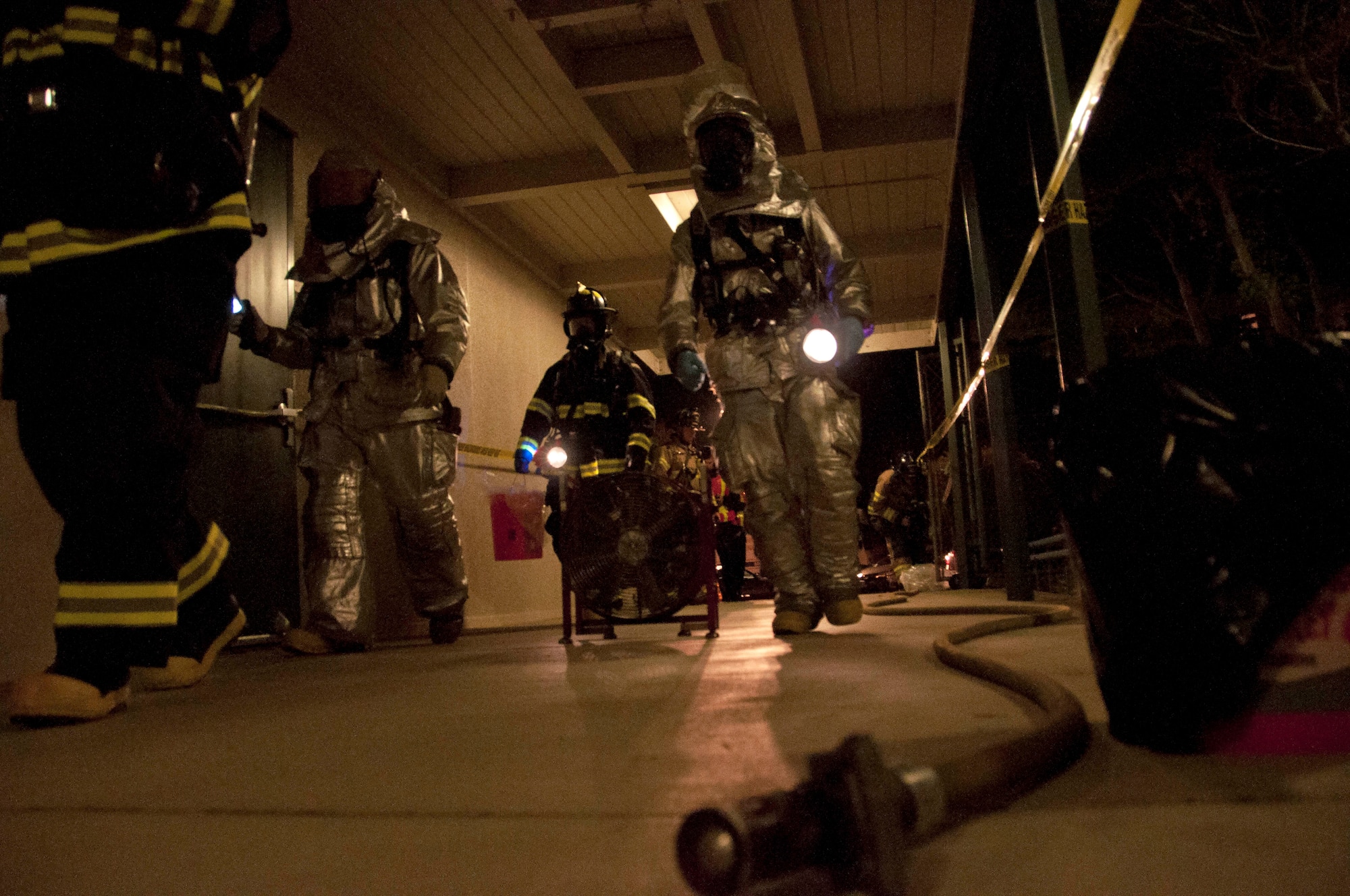 The hazardous material team enters the school to locate, analyze, identify and extradite the foreign substance left by the perpetrator in an active shooter exercise Nov. 14 at the Sierra Vista Elementary School in Vacavile, Calif. Travis and Solano County responders collaborated to respond to the massive exercise. (U.S. Air Force photo/Senior Airman Madelyn Brown)
