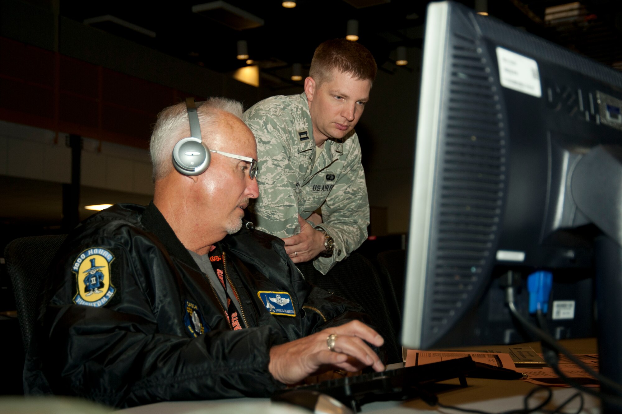 Doug Erlenbusch, 505th Training Squadron chief of combat operations (left) and Capt. Mark Wuerts, 505th TS test director (right), monitor operations during a test Nov. 21, 2013, at Nellis Air Force Base, Nev. The test is one of the first tests that are specifically aimed at degraded operations within the Air Operations Center. One way the 505th TS simulates degraded operations is through the assistance of the 57th Information Aggressor Squadron who simulate various adversaries. (U.S. Air Force photo by Airmen 1st Class Timothy Young)