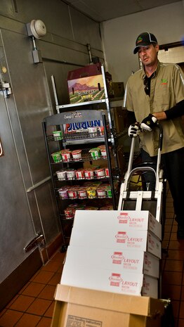 Jefferey Lorback, U.S. Foods delivery driver, delivers food being used for the Thanksgiving Day meal to the Crosswinds Dining Facility Nov. 25, 2013, at Nellis Air Force Base, Nev. The dining facility receives Thanksgiving food deliveries throughout the month of November. (U.S. Air Force photo by Senior Airman Matthew Lancaster)