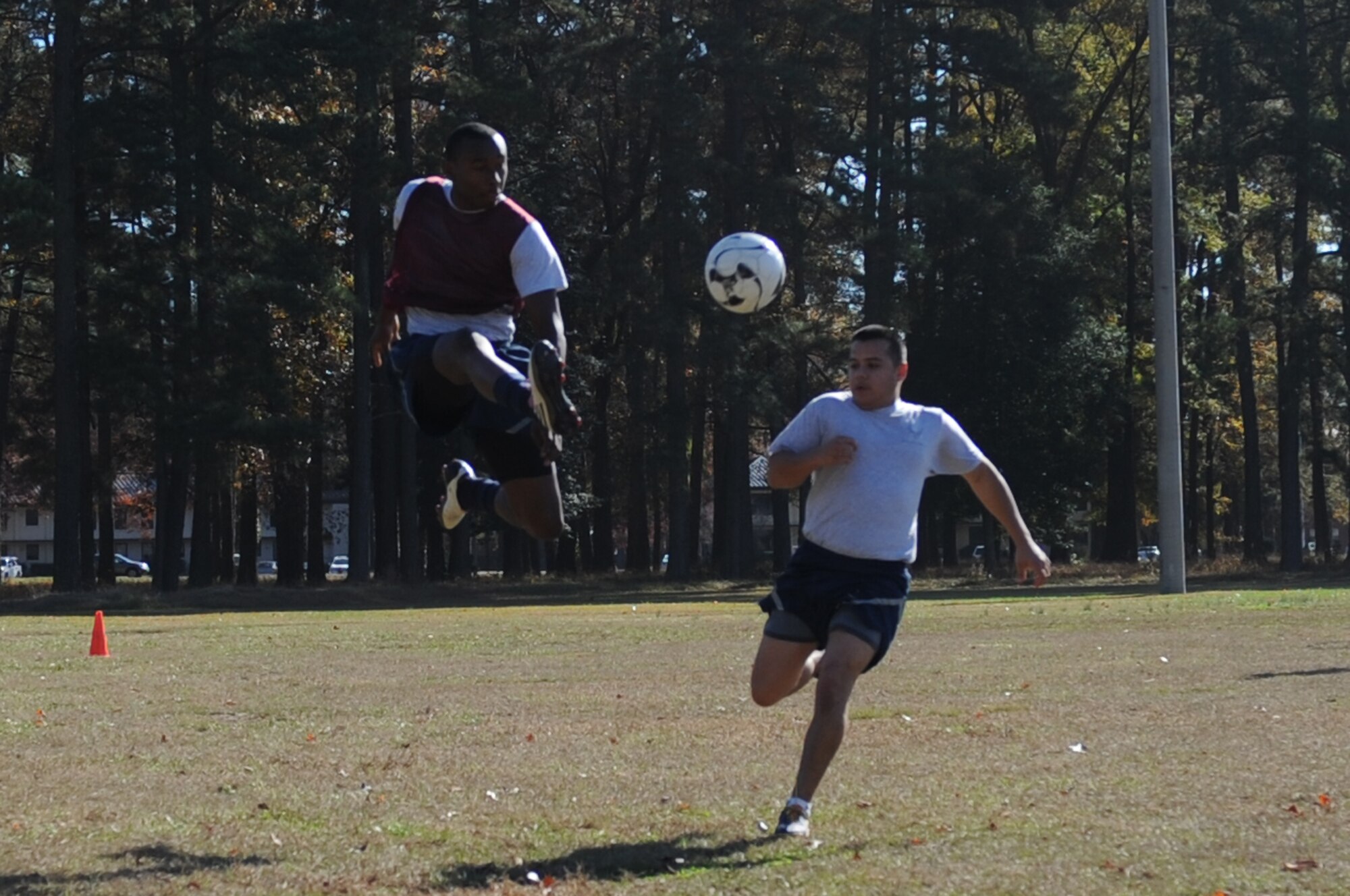 U.S. Air Force Airman 1st Class Alain Joseph, 336th Aircraft Maintenance Unit crew chief, jump kicks a ball out of the reach of Staff Sgt. Jason Estrada, 4th Equipment Maintenance Squadron aircraft structural maintenance, during a Wing Comprehensive Airman Fitness (CAF) Day event at Seymour Johnson Air Force Base, N.C., Nov. 22, 2013. CAF Day is a quarterly activity which promotes physical, social, mental and spiritual fitness. (U.S. Air Force photo by Tech. Sgt. Phillip Butterfield)