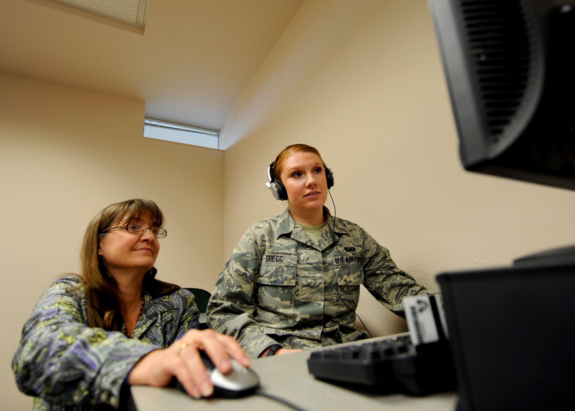 Becky Mays, 28th Force Support Squadron test control officer, assists Airman 1st Class Danielle Gregg, 28th FSS commander support staff apprentice, with taking a Defense Language Aptitude Battery at Ellsworth Air Force Base, S.D., Nov. 19, 2013. As a way of assessing an Airman’s ability to speak, understand and learn new languages, the Air Force administers the Defense Language Proficiency Test and Defense Language Aptitude Battery. (U.S. Air Force photo by Senior Airman Anania Tekurio/Released)