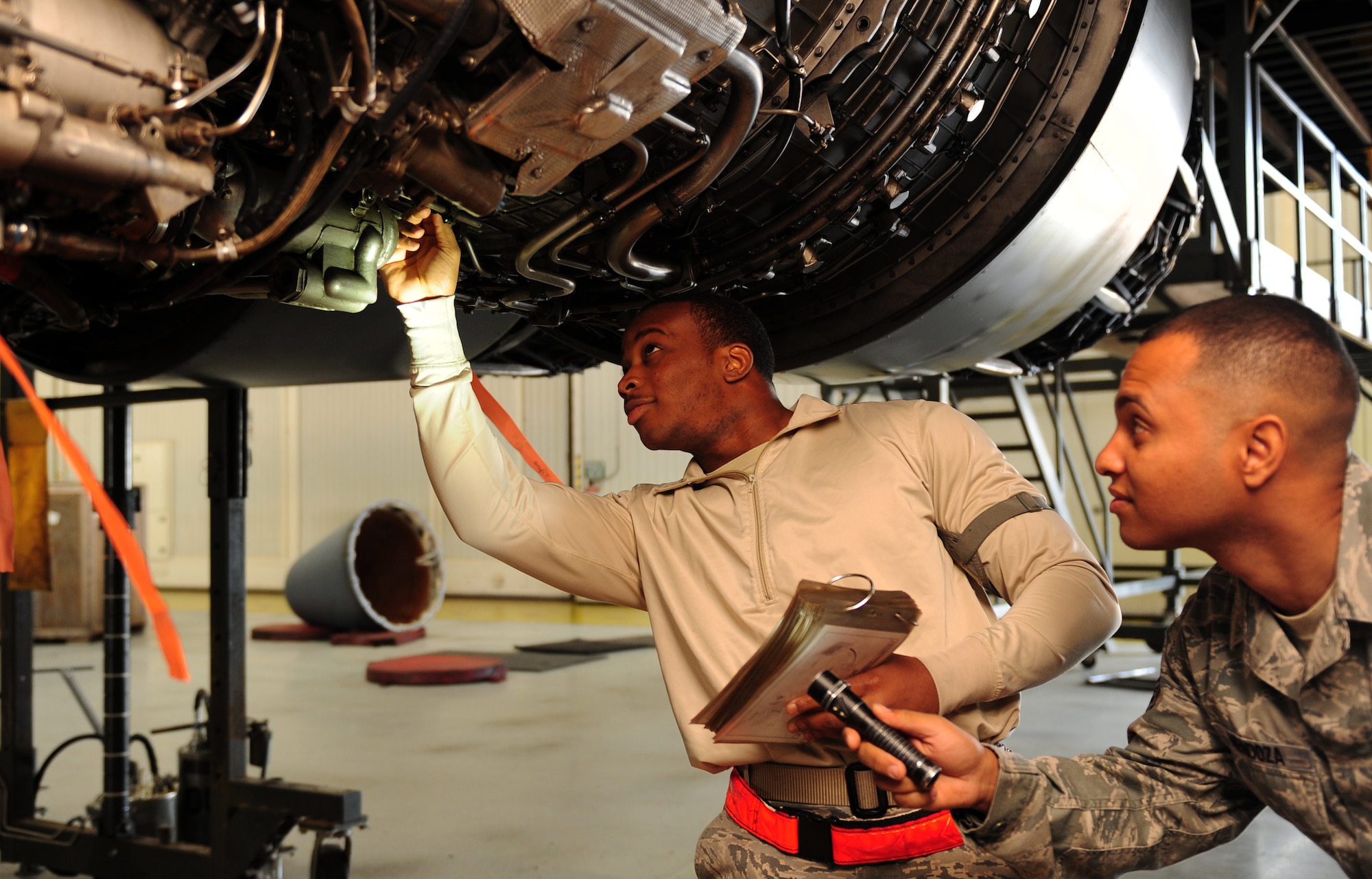U.S. Air Force Senior Airman Chris Alston, left, and Staff Sgt. Danel Mendoza, 7th Equipment Maintenance Squadron, inspect a F101-102 engine of a B-1B Lancer for leaks or damage Nov. 8, 2013, at Dyess Air Force Base, Texas. Inspecting for leaks is one of many virtual tasks performed by 7 EMS Airman, to ensure aircraft are safe for flight. (U.S. Air Force photo by Senior Airman Kia Atkins/Released)