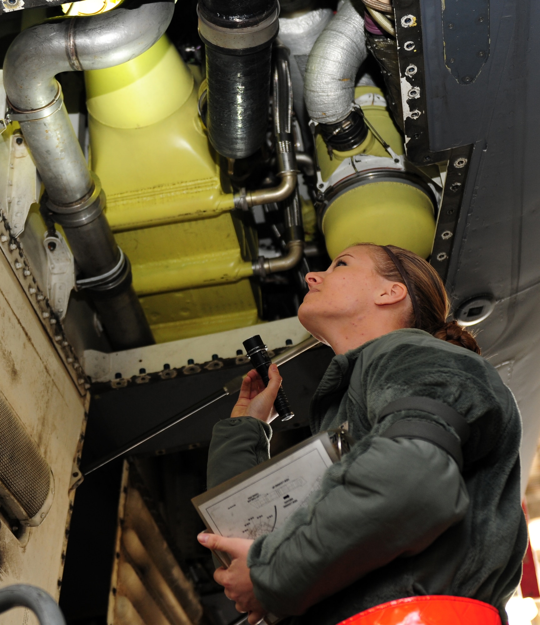 U.S. Air Force Airman 1st Class Tia Meredith, 7th Equipment Maintenance Squadron, follows her technical order while inspecting turbo compressors on a B-1B Lancer Nov. 8, 2013, at Dyess Air Force Base, Texas. Meredith inspects for anything that could possibly cause damage to an aircraft. (U.S. Air Force photo by Senior Airman Kia Atkins/Released)