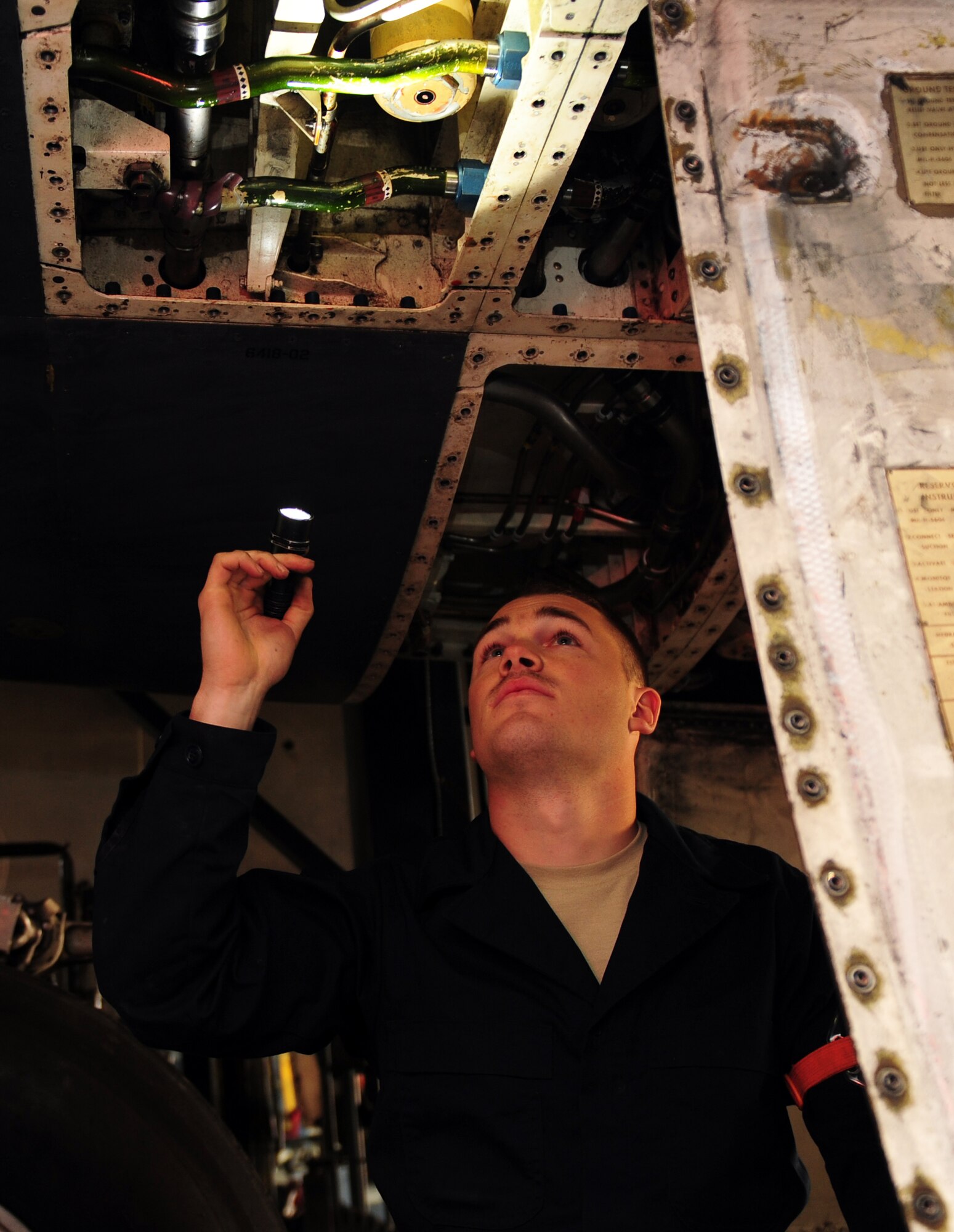 U.S. Air Force Airman 1st Class Alex Bloom, 7th Equipment Maintenance Squadron, inspects area two of a B-1B Lancer Nov. 8, 2013, at Dyess Air Force Base, Texas. Inspections such as this are designed to ensure the aircraft is operating safety and correctly prior to flight. (U.S. Air Force photo by Senior Airman Kia Atkins/Released)