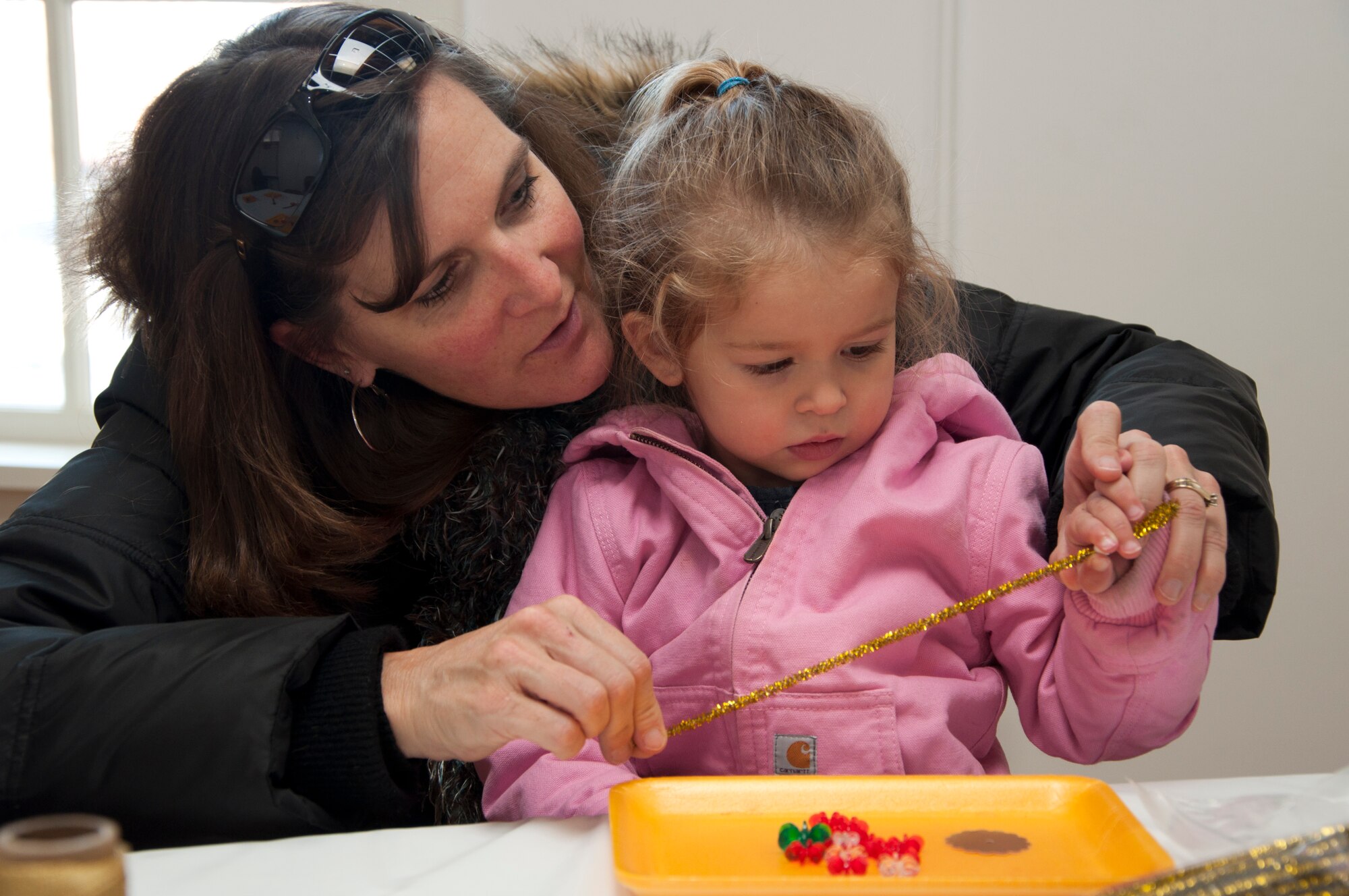 Cathy Smits works with her granddaughter Stella on arts and crafts at the Warren ICBM and Heritage Museum Christmas Open House Nov. 23, 2013. The museum had Victorian Christmas displays and decorations, arts and crafts, period-style candies, photos with Santa and more.  Stella is the daughter of Staff Sgt. Douglas Smits, 90th Civil Engineer Squadron Explosive Ordnance Disposal. (U.S. Air Force photo by Tech. Sgt. Stacy Foster)