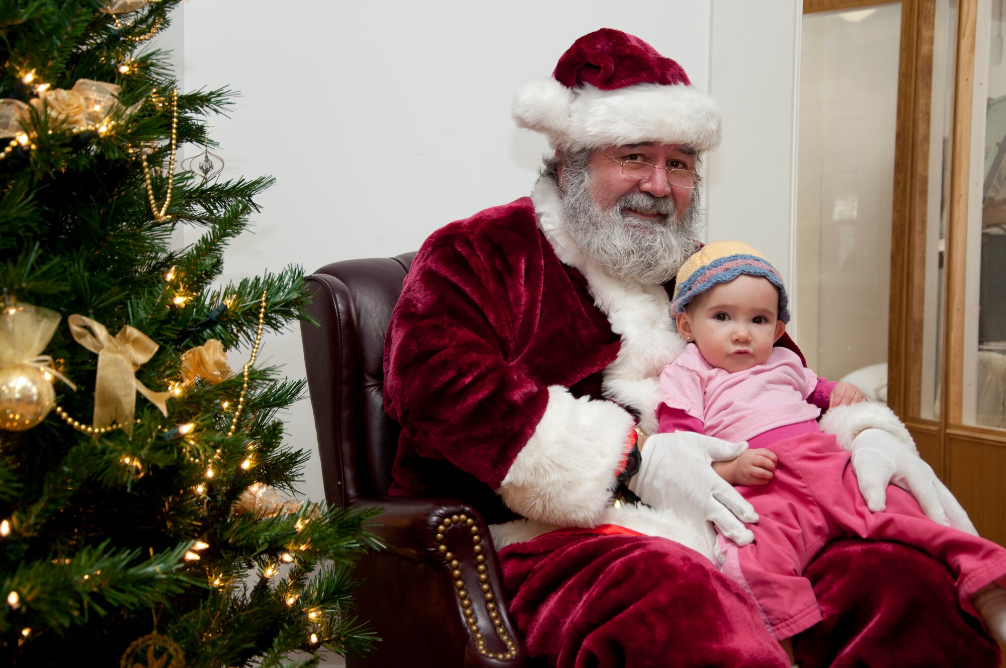 Montserrat Joyner, 11 months old, sits on Santa’s lap at the Warren ICBM and Heritage Museum Christmas Open House Nov. 23, 2013. The museum had Victorian Christmas displays and decorations, arts and crafts, period-style candies, photos with Santa and more. Montserrat is the daughter of Airman 1st Class Travis Joyner, 90th Munitions Squadron. (U.S. Air Force photo by Tech. Sgt. Stacy Foster)