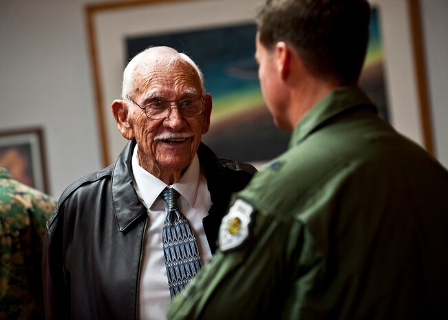 2nd Lt. retired Dean Whitaker, B-17 Flying Fortress pilot and World War II veteran, converses with Brig. Gen. Charles Moore, 57th Wing commander, during a WWII Veteran's breakfast Nov. 22, 2013, inside the Club at Nellis Air Force Base, Nev. Whitaker was a guest speaker and shared moments he experienced during WWII. (U.S. Air Force photo/Senior Airman Brett Clashman)
