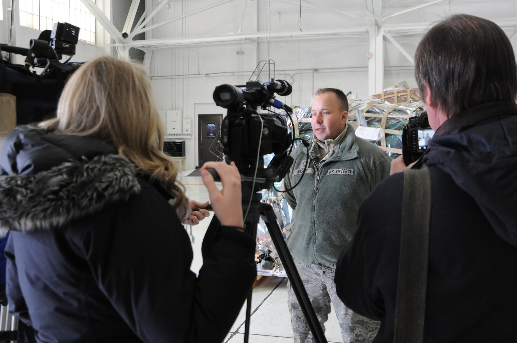 YOUNGSTOWN AIR RESERVE STATION, Ohio—Senior Master Sgt. Kevin Massie, 76th Aerial Port Squadron superintendent, discusses a humanitarian mission with local media personnel here, Nov. 25, 2013. A C-17 Globemaster III aircraft from the 446th Airlift Wing, Joint Base Lewis-McChord, Washington, arrived here to pick up 14 pallets of humanitarian cargo destined to Guatemala via the Denton Program, which provides military transportation for approved humanitarian assistance commodities destined for approved countries. Mission of Love, a charity based in Austintown, Ohio, collected the cargo. (U.S. Air Force photo/Eric White).