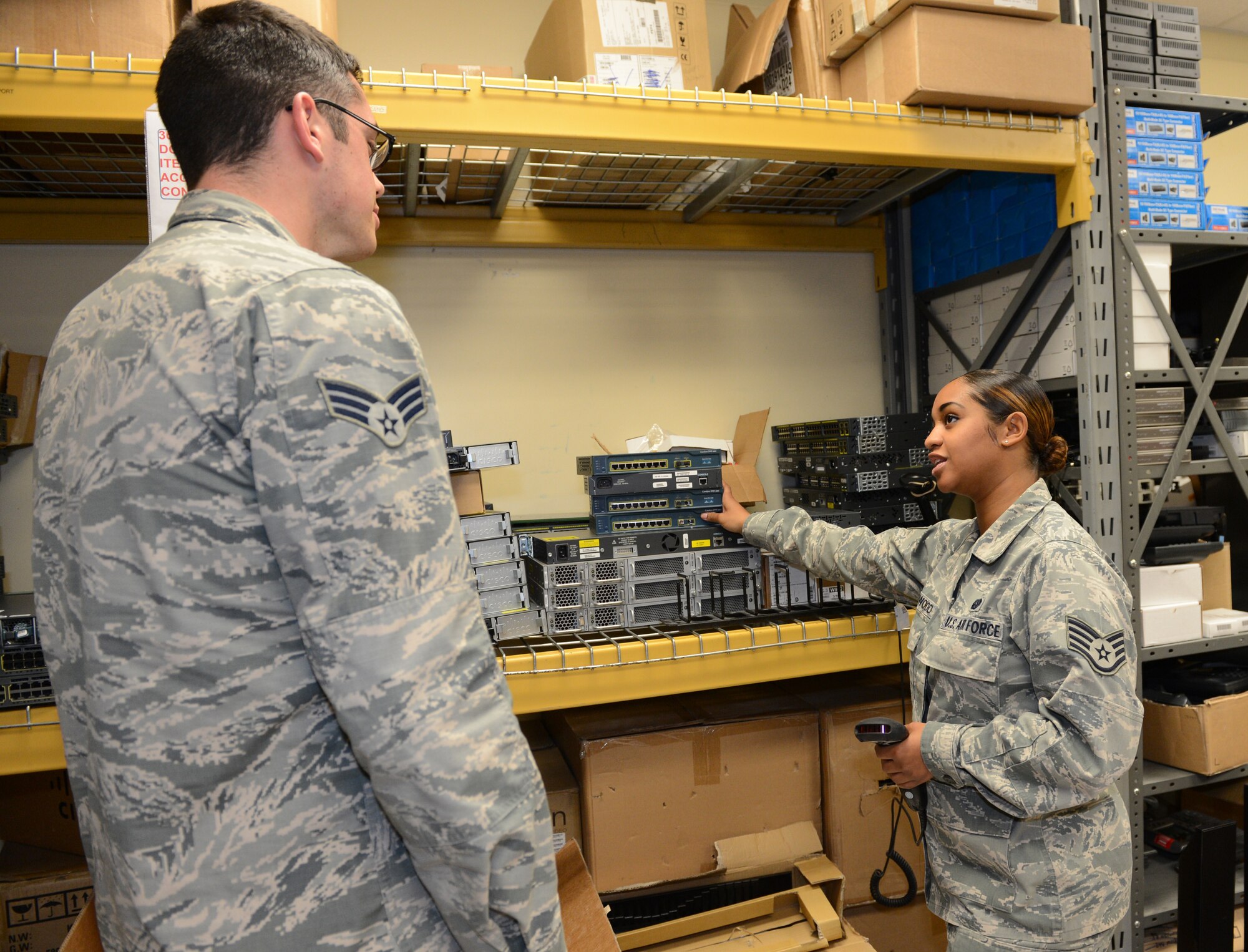 U.S. Air Force Staff Sgt. Noelle Norwood, 20th Communications Squadron information technology asset manager, briefly goes over some computer equipment with an Airman at Shaw Air Force Base, S.C., Nov. 22, 2013. She is one of three in her shop who handles the inventory on government electronic equipment for Shaw. 
(U.S. Air Force Photo by. Airman 1st Class Diana Giannetti/ Released)
