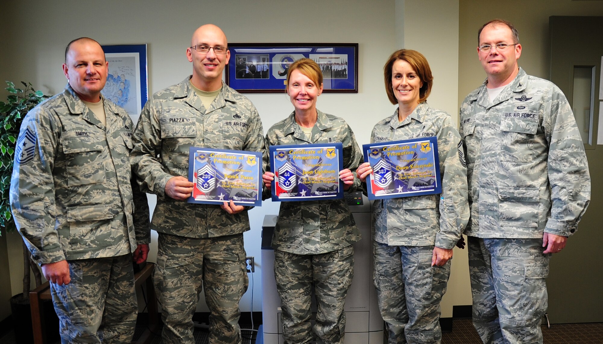 Senior Master Sgt. Patrick Piazza, 436th Maintenance Squadron maintenance flight chief, Senior Master Sgt. Janet Lightburn, 436th Airlift Wing career assistance advisor, and Senior Master Sgt. Dawn Kolczynski, 436th Aerospace Medical Squadron superintendent, receive their promotion certificates from Col. Rick Moore, 436th AW commander, and Chief Master Sgt. James Smith, 436th AW command chief, Nov. 14, 2013, at Dover Air Force Base, Del. Senior Master Sgt. Michael Watson, 436th Operations Support Squadron aircrew flight equipment superintendent, was also a chief master sergeant selectee but was not in the photo because he was deployed. (U.S. Air Force photo/Airman 1st Class Ashlin Federick)