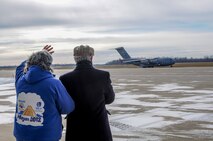 YOUNGSTOWN AIR RESERVE STATION, Ohio—Kathleen Price (left), founder of the Mission of Love Foundation, stands with her husband Robert and waves to a taxiing C-17 aircraft from the 446th Airlift Wing, Joint Base Lewis-McChord, Washington, Nov. 25, 2013. The C-17 arrived here to pick up 14 pallets of humanitarian cargo destined to Guatemala via the Denton Program, which provides military transportation for approved humanitarian assistance commodities destined for approved countries. Mission of Love, a charity based in Austintown, Ohio, collected the cargo. (U.S. Air Force photo/Eric White).