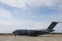 YOUNGSTOWN AIR RESERVE STATION, Ohio—A C-17 Globemaster III aircraft from the 446th Airlift Wing, Joint Base Lewis-McChord, Washington, taxis shortly after landing here, Nov. 25, 2013. The C-17 arrived here to pick up 14 pallets of humanitarian cargo destined to Guatemala via the Denton Program, which provides military transportation for approved humanitarian assistance commodities destined for approved countries. Mission of Love, a charity based in Austintown, Ohio, collected the cargo. (U.S. Air Force photo/Eric White).