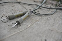 Non-electric lighting fuses remain after the detonation of explosives at Hurlburt Field, Fla., Nov. 21, 2013. Airmen used various types of fuses and explosives as part of their monthly qualification training. (U.S. Air Force photo/Senior Airman Kentavist P. Brackin)