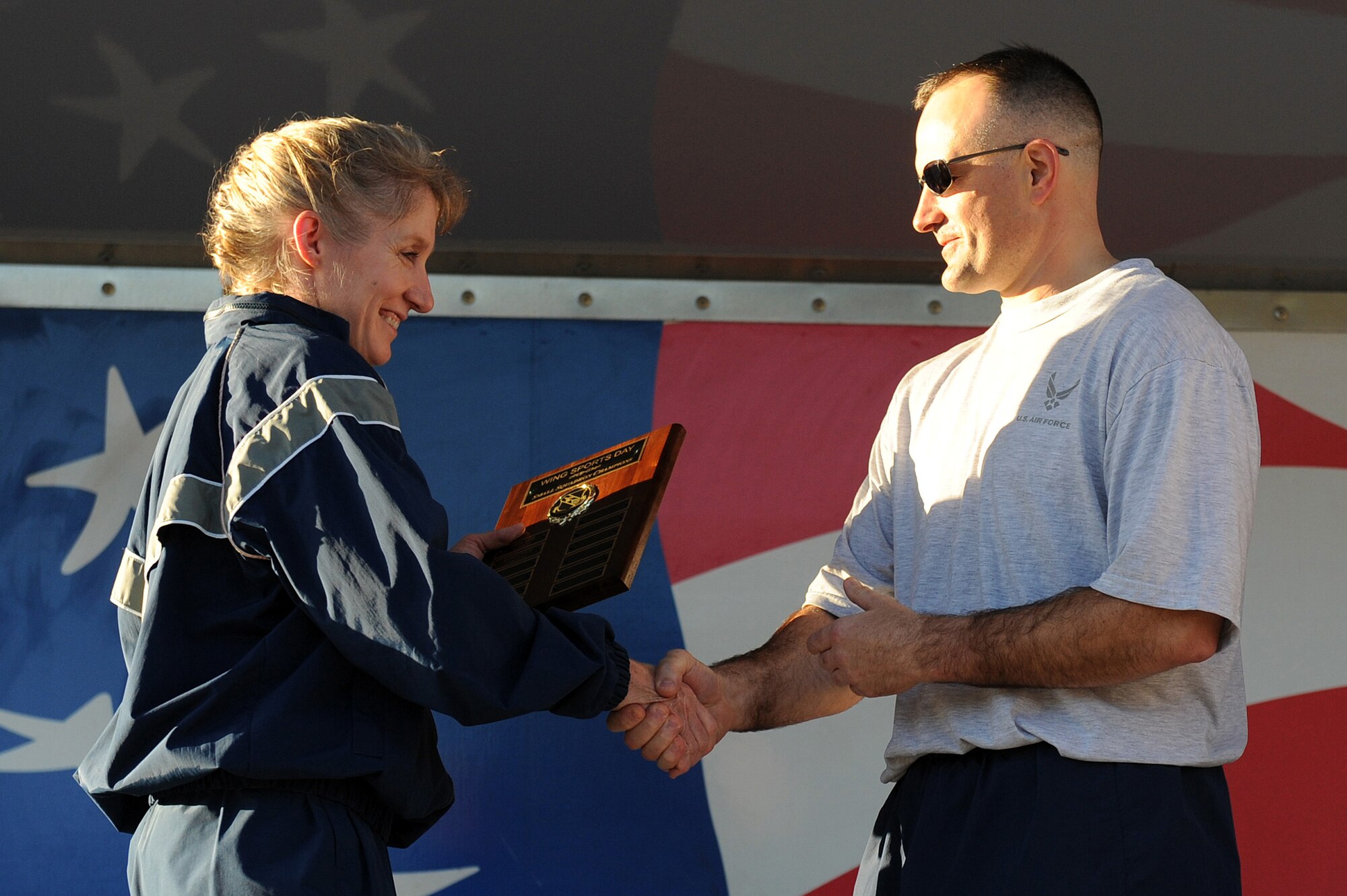 U.S. Air Force Lt. Col. Charles Parada, 4th Force Support Squadron commander, receives the small-squadron championship award from Col. Jeannie Leavitt, 4th Fighter Wing commander, for the squadron’s success in the wing’s Comprehensive Airman Fitness Day at Seymour Johnson Air Force Base, N.C., Nov. 22, 2013. Airmen participated in various sports such as golf, basketball and dodge ball to foster resiliency through friendly competition and team building. (U.S. Air Force photo by Airman 1st Class Aaron J. Jenne)
