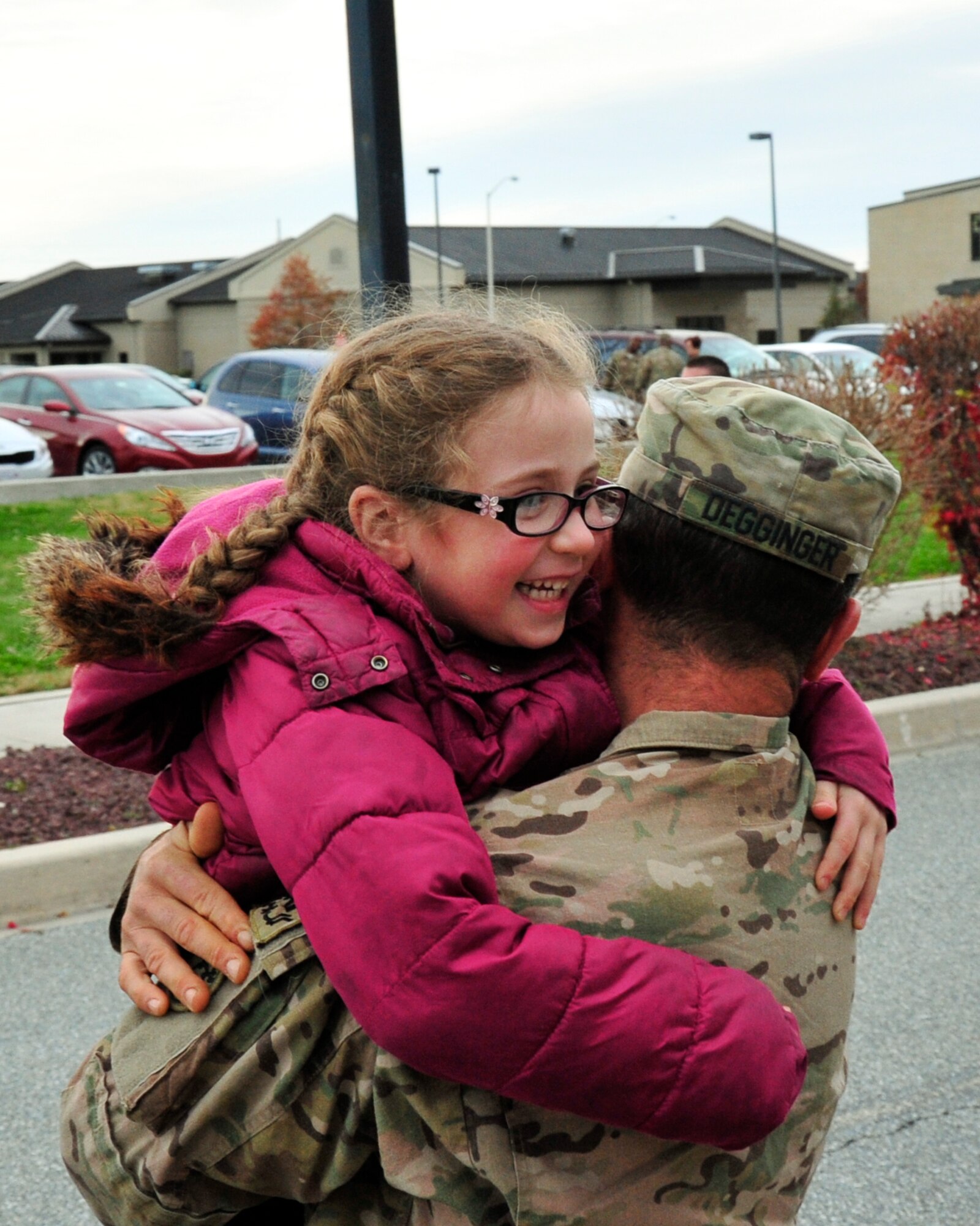 U.S. Army Reserve Spc. Seth Degginger, 946th Transportation Company motor transport operator, hugs his daughter, Sofia, after returning home from a 90 day deployment to Afghanistan Nov. 23, 2013, at the passenger terminal on Dover Air Force Base, Del. Degginger and 60 other soldiers were deployed to Afghanistan, supporting convoy operations. (U.S. Air Force photo/Airman 1st Class William Johnson)