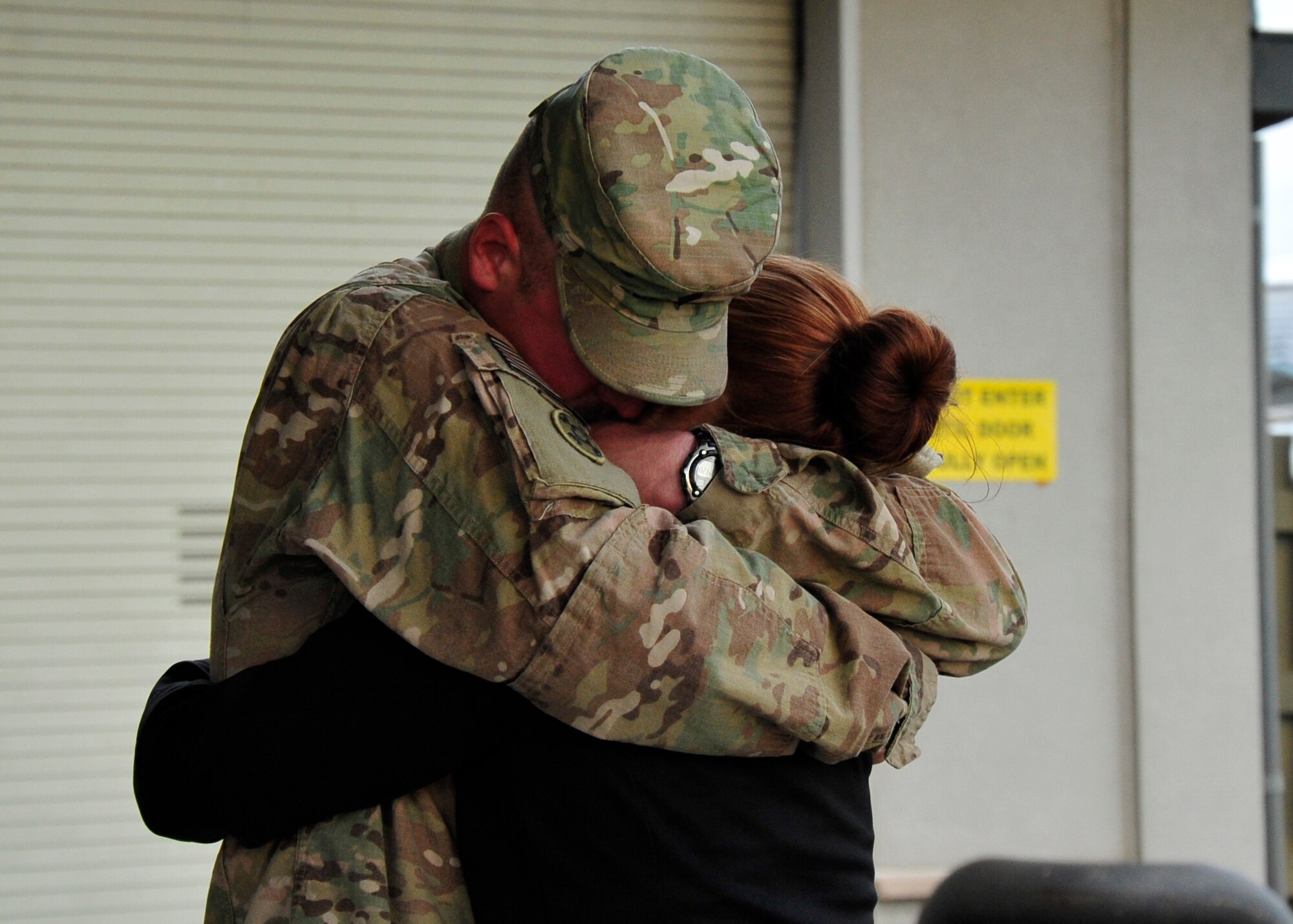 U.S. Army Reserve Spc. Franklin Messick, 946th Transportation Company motor transport operator, hugs his wife, Victoria, Nov. 23 2013, at the passenger terminal on Dover Air Force Base, Del. Messick returned from a 90-day deployment to Afghanistan where his unit conducted convoy operations. (U.S. Air Force photo/Airman 1st Class William Johnson)
