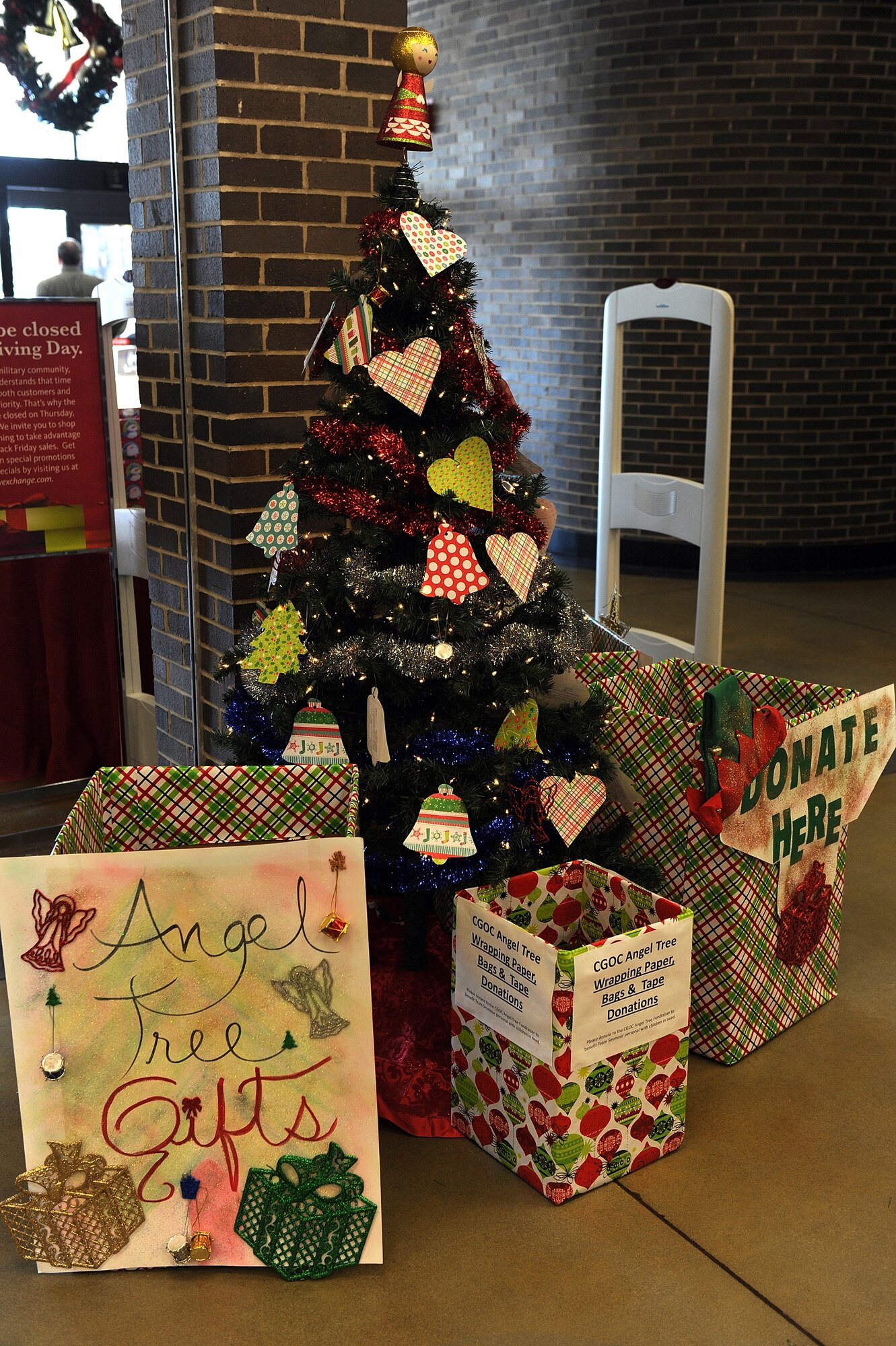 The Angel Tree and donation boxes are set up at the entrance of the Xchange to help provide gifts for children this holiday season at Seymour Johnson Air Force Base, N.C., Nov. 21, 2013. Members of the Company Grade Officers’ Council sponsor the event annually and first sergeants provide the names of children and families who may benefit from this program during the holidays. (U.S. Air Force photo by Airman 1st Class Aaron J. Jenne)