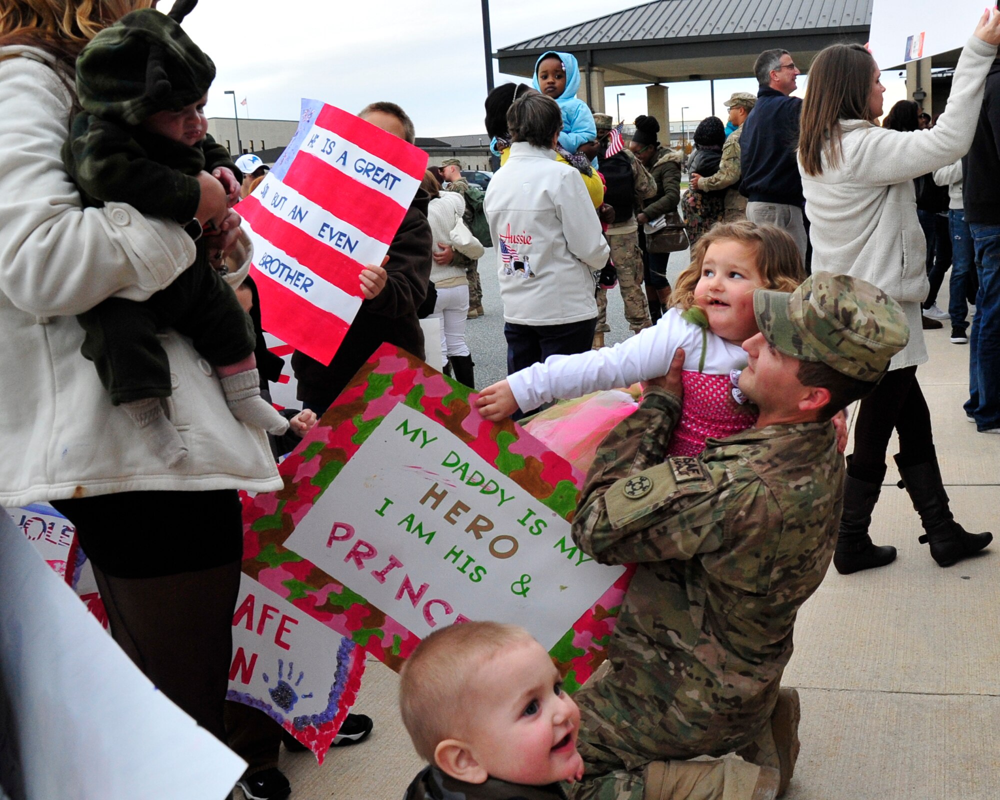 U.S. Army Reserve Spc. Robert Martin, 946th Transportation Company motor transport operator, holds his daughter, Hannah Martin, after coming home from a deployment to Afghanistan Nov. 23, 2013, at Dover Air Force Base, Del. Martin and 60 other soldiers were deployed to Afghanistan, supporting convoy operations. (U.S. Air Force photo/Airman 1st Class William Johnson) 
