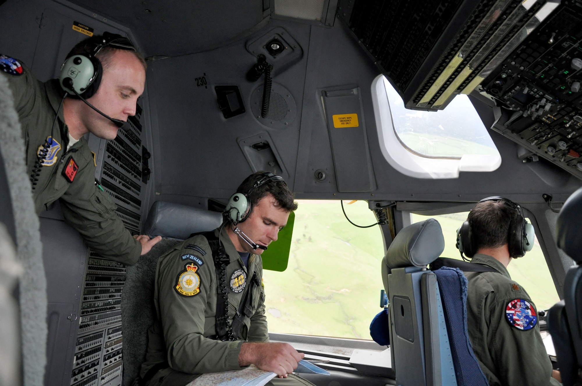 OHAKEA, New Zealand -- (Left) U.S. Air Force 1st Lt. Eric Darwin, 517th EAS pilot, and Royal New Zealand Air Force Flight Lt. Jimmy Davidson, a pilot for RNZAF 40 Squadron, check navigation charts during low-level tactical flying training on a U.S. Air Force C-17 Globemaster III during the multilateral RNZAF-sponsored tactical airlift exercise, Kiwi Flag, at Royal New Zealand Air Force Base Ohakea, New Zealand. Kiwi Flag personnel are supporting Exercise Southern Katipo -- held in New Zealand’s South Island -- by managing air operations and providing cargo and passenger airlift including tactical air drops to SK participants. (U.S. Air Force photo by Senior Master Sgt. Denise Johnson/Released)