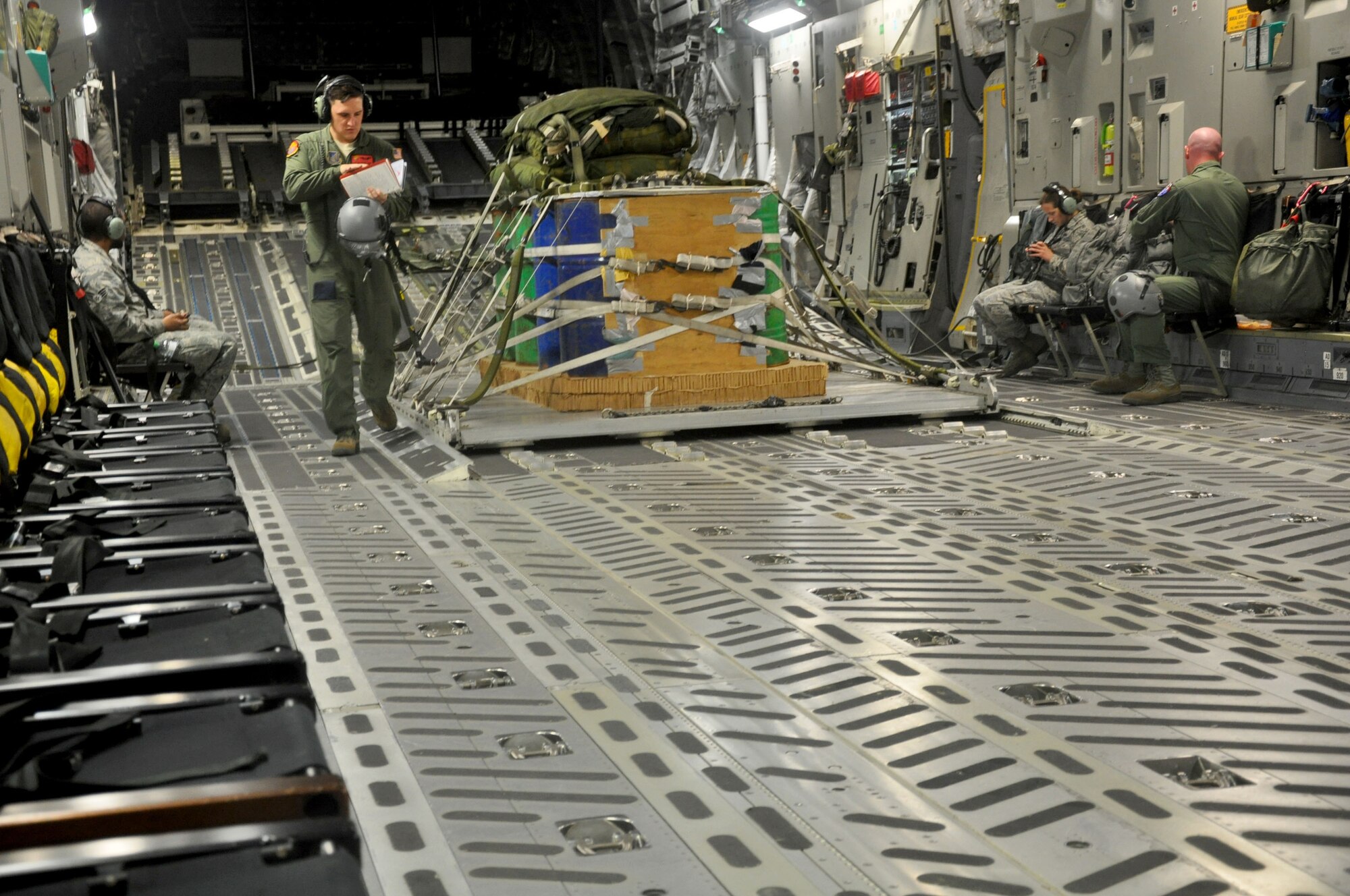 OHAKEA, New Zealand -- Senior Airman Caleb Williams, 517th Expeditionary Airlift Squadron loadmaster, walks past a cargo pallet scheduled for aerial delivery onboard a C-17 Globemaster III during the multilateral RNZAF-sponsored tactical airlift exercise, Kiwi Flag, at Royal New Zealand Air Force Base Ohakea, New Zealand. Kiwi Flag personnel are supporting Exercise Southern Katipo -- held in New Zealand’s South Island. (U.S. Air Force photo by Senior Master Sgt. Denise Johnson/Released)