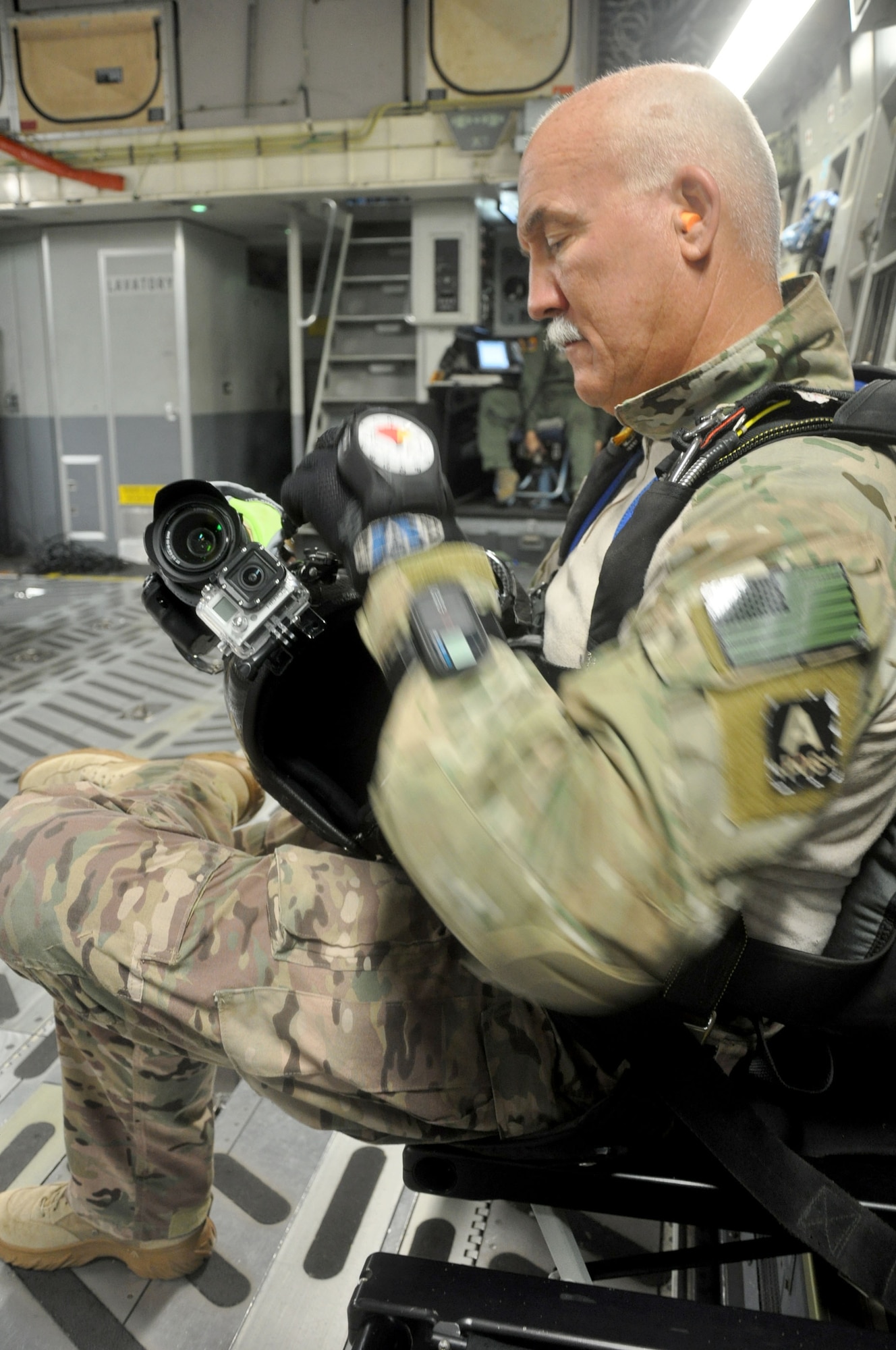 OHAKEA, New Zealand -- Chief Master Sgt. Paul Koester, 517th Expeditionary Airlift Squadron jumpmaster, secures the protective covering on his helmet camera as he prepares to execute a high-altitude, low-opening jump from a C-17 Globemaster III during the multilateral RNZAF-sponsored tactical airlift exercise, Kiwi Flag, at Royal New Zealand Air Force Base Ohakea, New Zealand. Kiwi Flag personnel are supporting Exercise Southern Katipo -- held in New Zealand’s South Island -- by managing air operations and providing cargo and passenger airlift including tactical air drops to SK participants. (U.S. Air Force photo by Senior Master Sgt. Denise Johnson/Released)