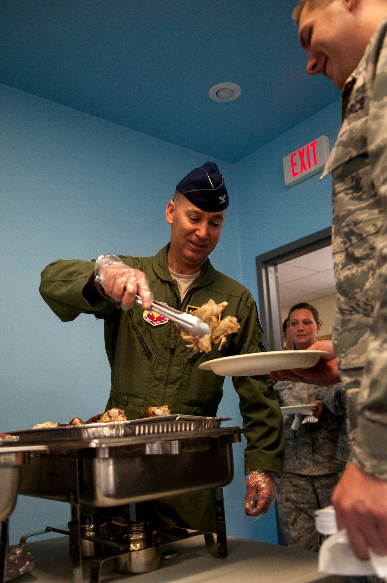 U.S. Air Force Col. Chad Franks, 23d Wing commander, helps serve a meal at the Thanksgiving Luncheon at Moody Air Force Base, Ga., Nov. 21, 2013. Base leaders served turkey, ham, side dishes and desert to Moody Airmen for the event.  (U.S. Air Force photo by Airman 1st Class Sandra Marrero/released)
