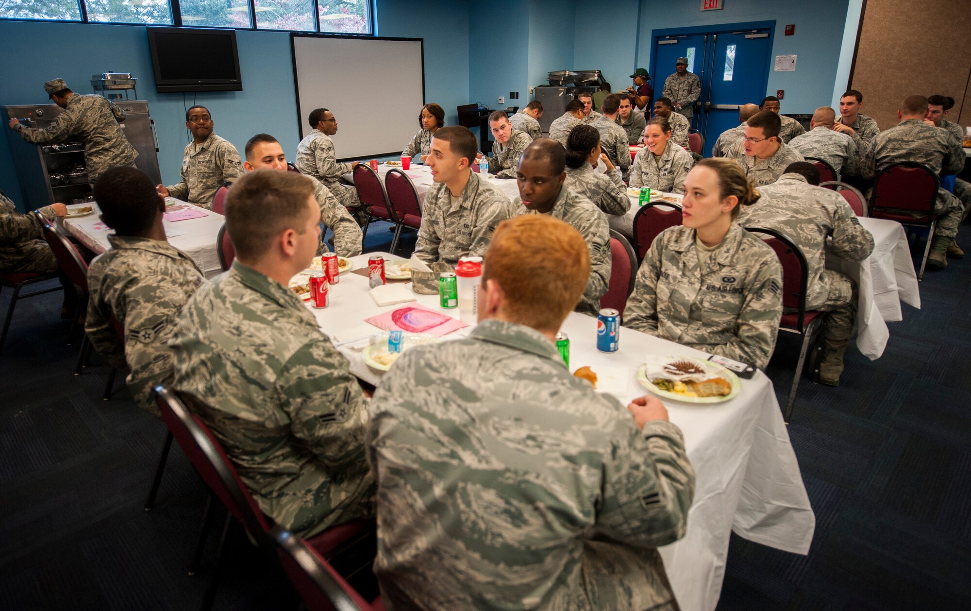 Moody Airmen sit down for a traditional Thanksgiving meal at Moody Air Force Base, Ga., Nov. 21, 2013. Airmen E-4 and below, who might not have a home-cooked meal on the holiday, were invited to the event. (U.S. Air Force photo by Airman 1st Class Sandra Marrero/released)
