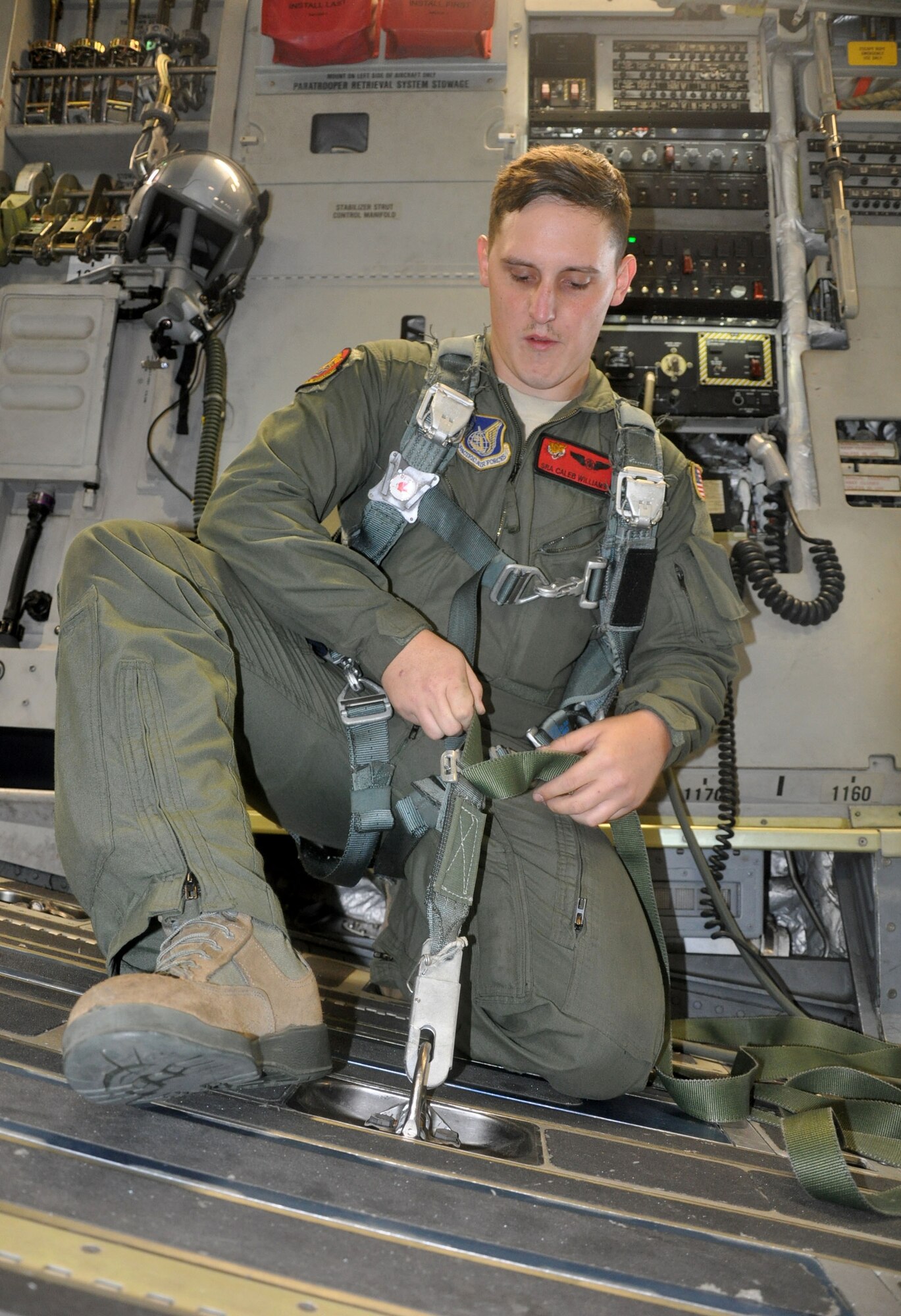 OHAKEA, New Zealand -- Senior Airman Caleb Williams, 517th Expeditionary Airlift Squadron loadmaster, checks his tie-down strap in preparation for cargo and personnel drops during the multilateral RNZAF-sponsored tactical airlift exercise, Kiwi Flag, at Royal New Zealand Air Force Base Ohakea, New Zealand. Kiwi Flag personnel are supporting Exercise Southern Katipo -- held in New Zealand’s South Island. (U.S. Air Force photo by Senior Master Sgt. Denise Johnson/Released)