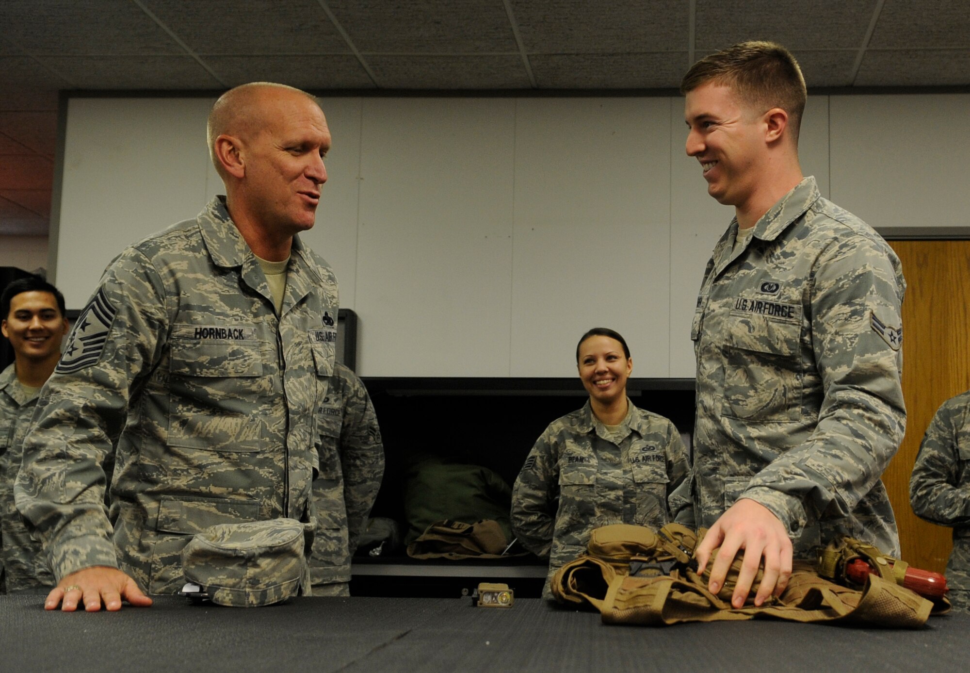 Airman 1st Class Jared Schanen, 509th Operations Support Squadron aircrew flight equipment technician, explains pilot vests to Chief Master Sgt. Brian Hornback, Air Force Global Strike Command command chief, during his visit to Whiteman Air Force Base, Mo., Nov. 13, 2013. After Whiteman, Hornback will make stops at all the other AFGSC bases. (U.S. Air Force photo by Staff Sgt. Alexandra M. Boutte/Released)