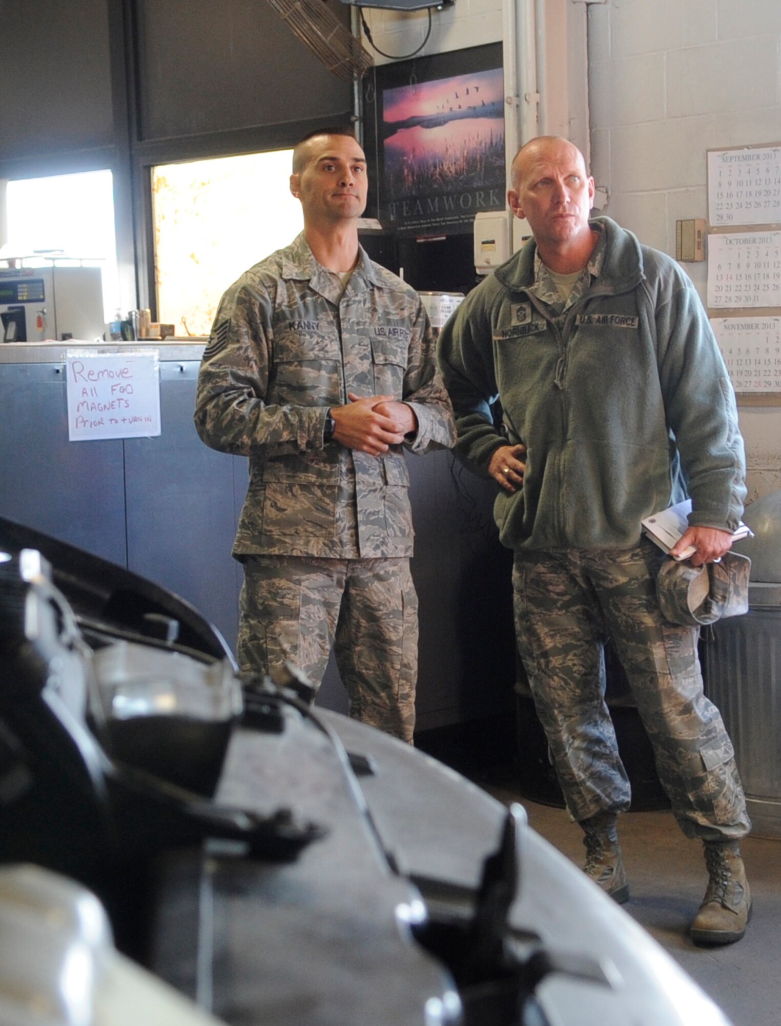 Tech. Sgt. Scott Kanny, 509th Logistics Readiness Squadron vehicle management and analysis journeyman, walks Chief Master Sgt. Brian Hornback, Air Force Global Strike Command command chief, through his squadron at Whiteman Air Force Base, Mo., Nov. 13, 2013. This was Hornback’s first stop on his visit to all AFGSC bases before his retirement in 2014. (U.S. Air Force photo by Staff Sgt. Alexandra M. Boutte/Released)