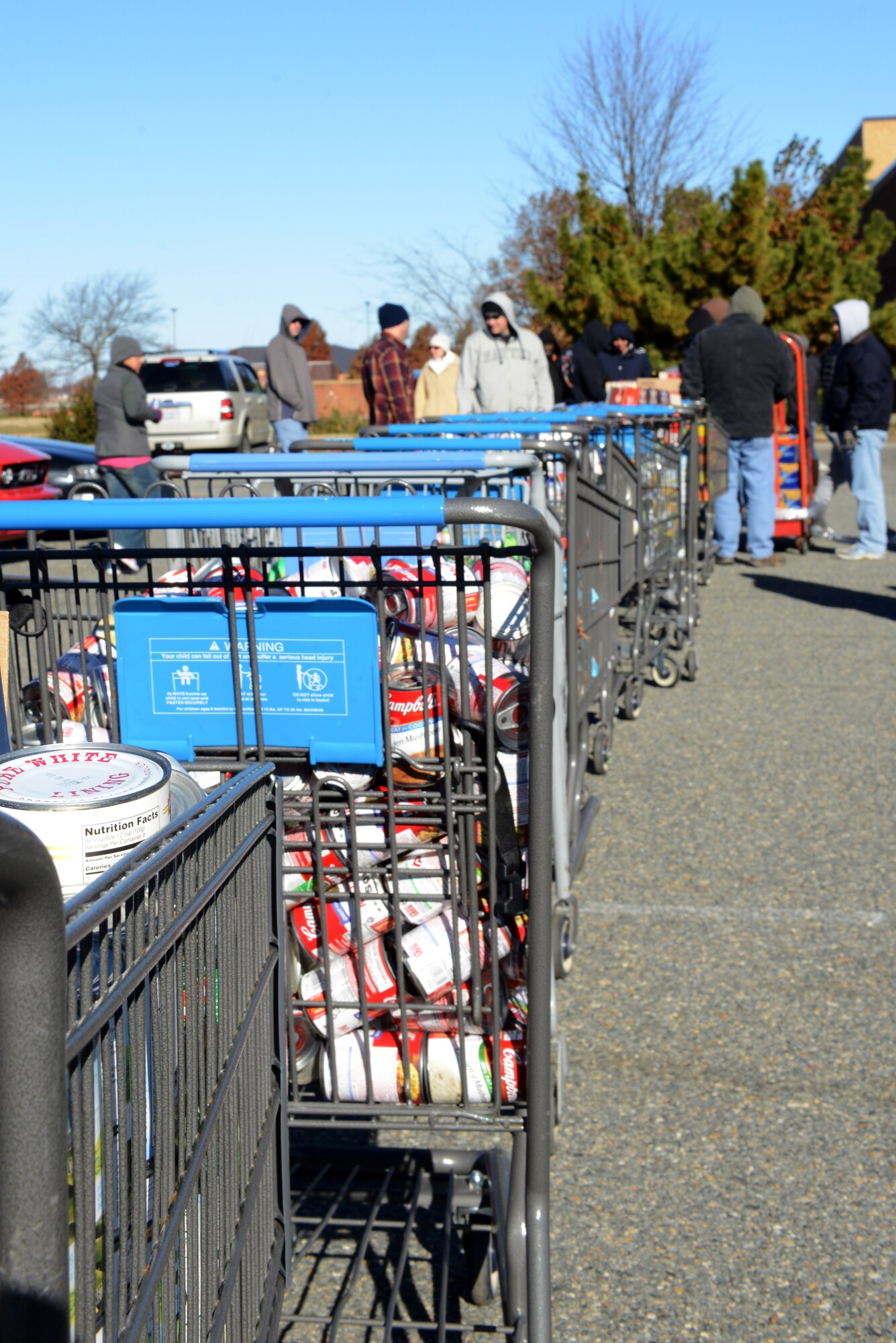 Volunteers pack food donations into “baskets” as part of an Operation Warmheart holiday food drive at Langley Air Force Base, Va., Nov. 24, 2013. The baskets will be distributed to Langley Airmen who may be struggling financially during the holidays or throughout the year. (U.S. Air Force photo by Airman 1st Class Kimberly Nagle/Released)  