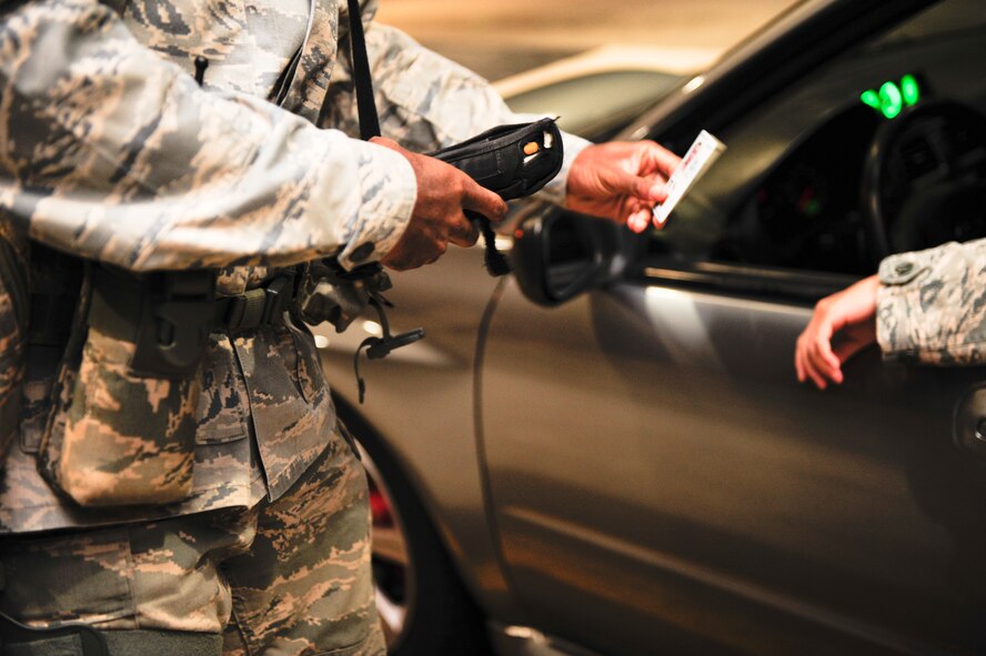 Senior Airman Jeffery Bell, 1st Special Operations Security Forces Squadron patrolman, checks an ID card with a Defense Biometric Identification System at a gate on Hurlburt Field, Fla., Nov. 19, 2013. DBIDS verifies the access authorization of everyone who enters the installation. (U.S. Air Force photo/Senior Airman Krystal M. Garrett)