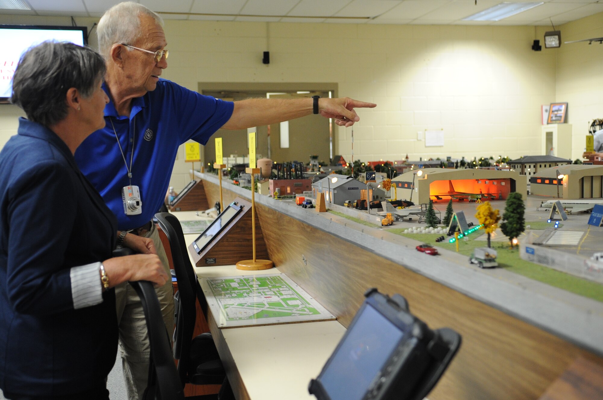 GOODFELLOW AIR FORCE BASE, Texas -- Dr. Mike Manning, a former Air Force firefighter, points out scenarios to Lynn Manning on the Norma Brown Air Force Base Simulator at the Louis F. Garland Department of Defense Fire Academy Sept. 16. Built in 1978 for the Advance Fire Technology course, the trainer gives students the opportunity to build on-scene commander experience. (U.S. Air Force photo/ Staff Sgt. Laura R. McFarlane)