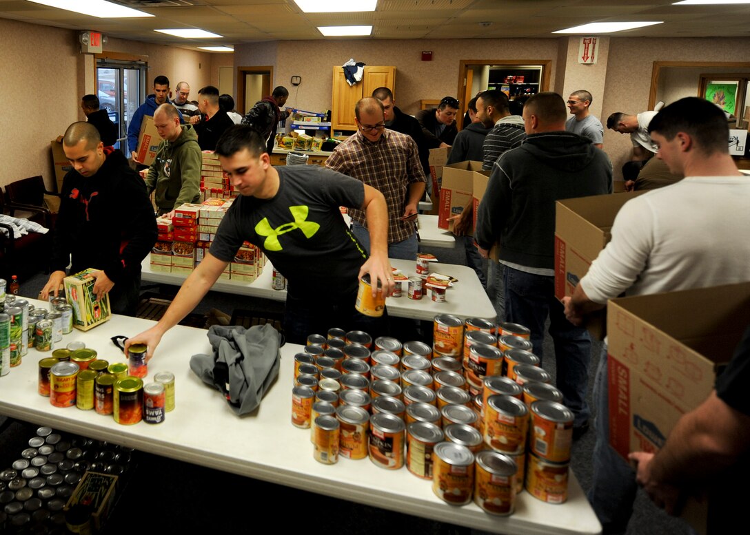 Airman Leadership School students assemble Thanksgiving meal baskets during an event held in conjunction with Operation Warmheart at Ellsworth Air Force Base, S.D., Nov. 16, 2013.  Each basket contained ingredients to make traditional Thanksgiving dishes including mashed potatoes, pumpkin pie, green bean casserole and turkey or ham. (U.S. Air Force photo by Senior Airman Anania Tekurio/Released)