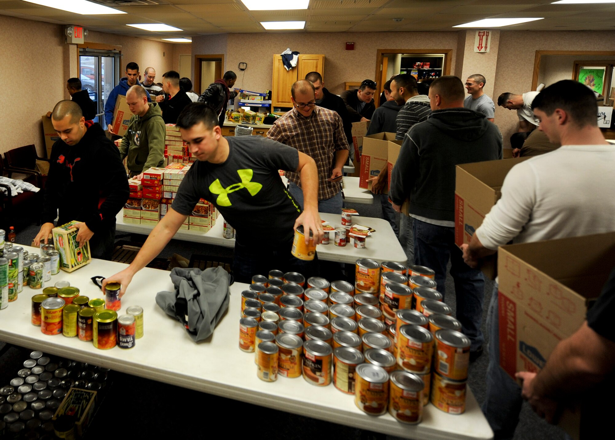 Airman Leadership School students assemble Thanksgiving meal baskets during an event held in conjunction with Operation Warmheart at Ellsworth Air Force Base, S.D., Nov. 16, 2013.  Each basket contained ingredients to make traditional Thanksgiving dishes including mashed potatoes, pumpkin pie, green bean casserole and turkey or ham. (U.S. Air Force photo by Senior Airman Anania Tekurio/Released)
