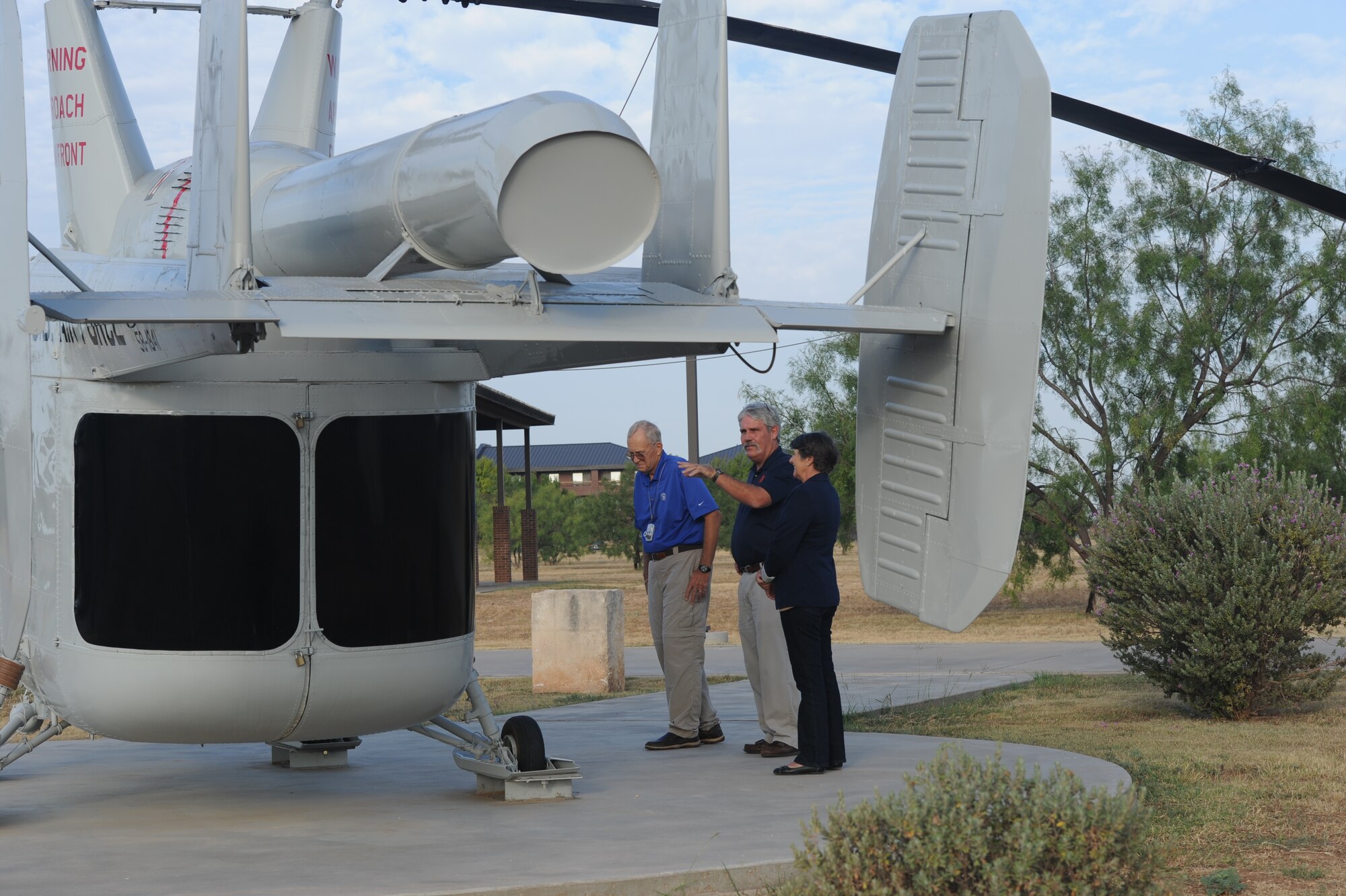 GOODFELLOW AIR FORCE BASE, Texas -- Dr. Mike Manning, a former Air Force firefighter, Mike Robertson, 312th Training Squadron chief of training development, and Lynn Manning, look over a 1958 H-43B helicopter at the Department of Defense Fallen Firefighters Memorial Sept. 16. The H-43B on display here entered the U.S. Air Force inventory in 1959 and served as a ground trainer until 1976. (U.S. Air Force photo/ Staff Sgt. Laura R. McFarlane)