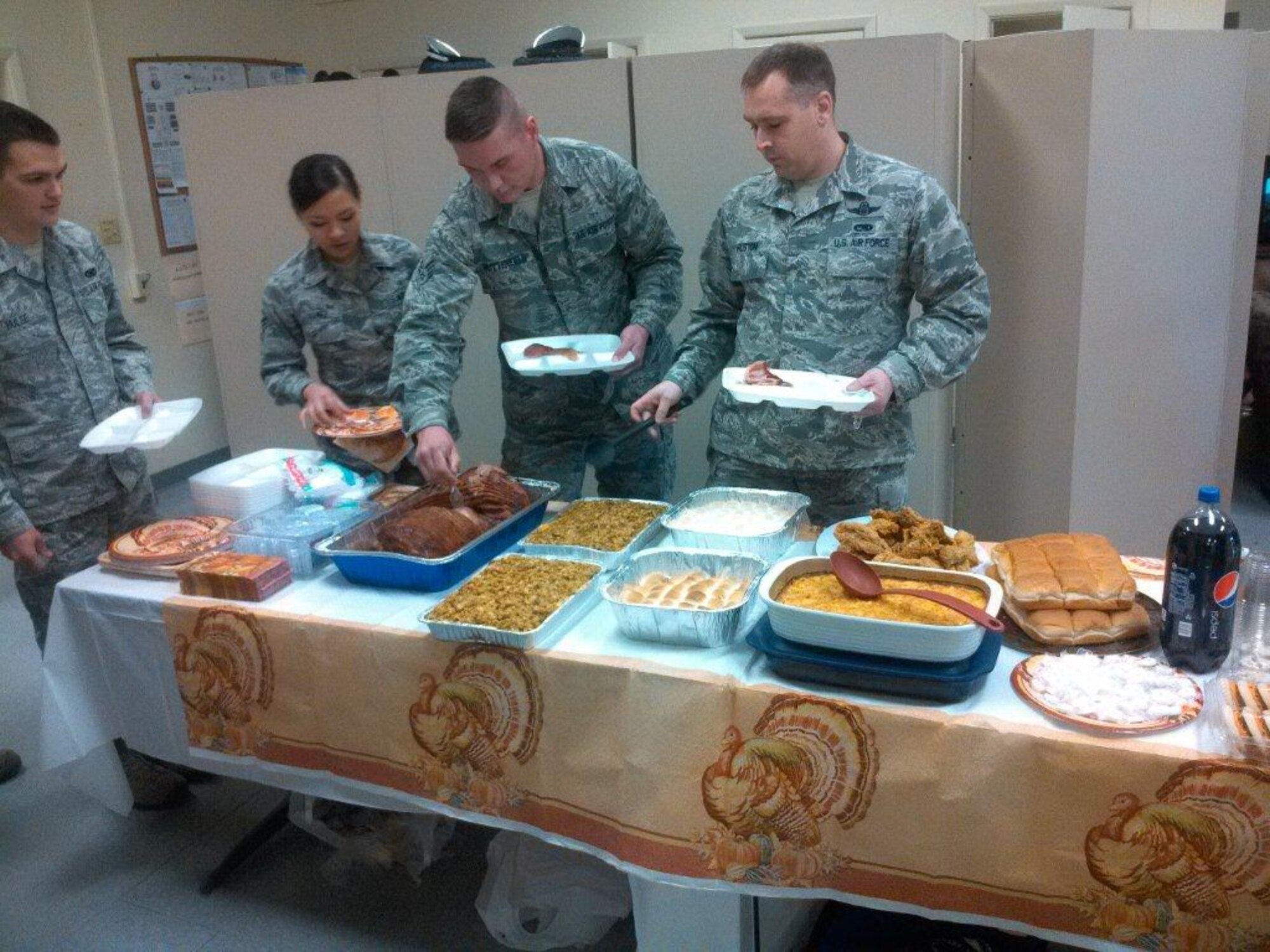 Members of the Kirtland Honor Guard enjoy a homebaked meal from the Rising Six.  The top four organizations at the base - the First Sergeants Group, Rising Six, Top Three and Chiefs Group - are providing a quarterly meal to the honor guard members in an effort to show appreciation for their efforts and thank them for their professionalism in representing the base. (Courtesy photo)