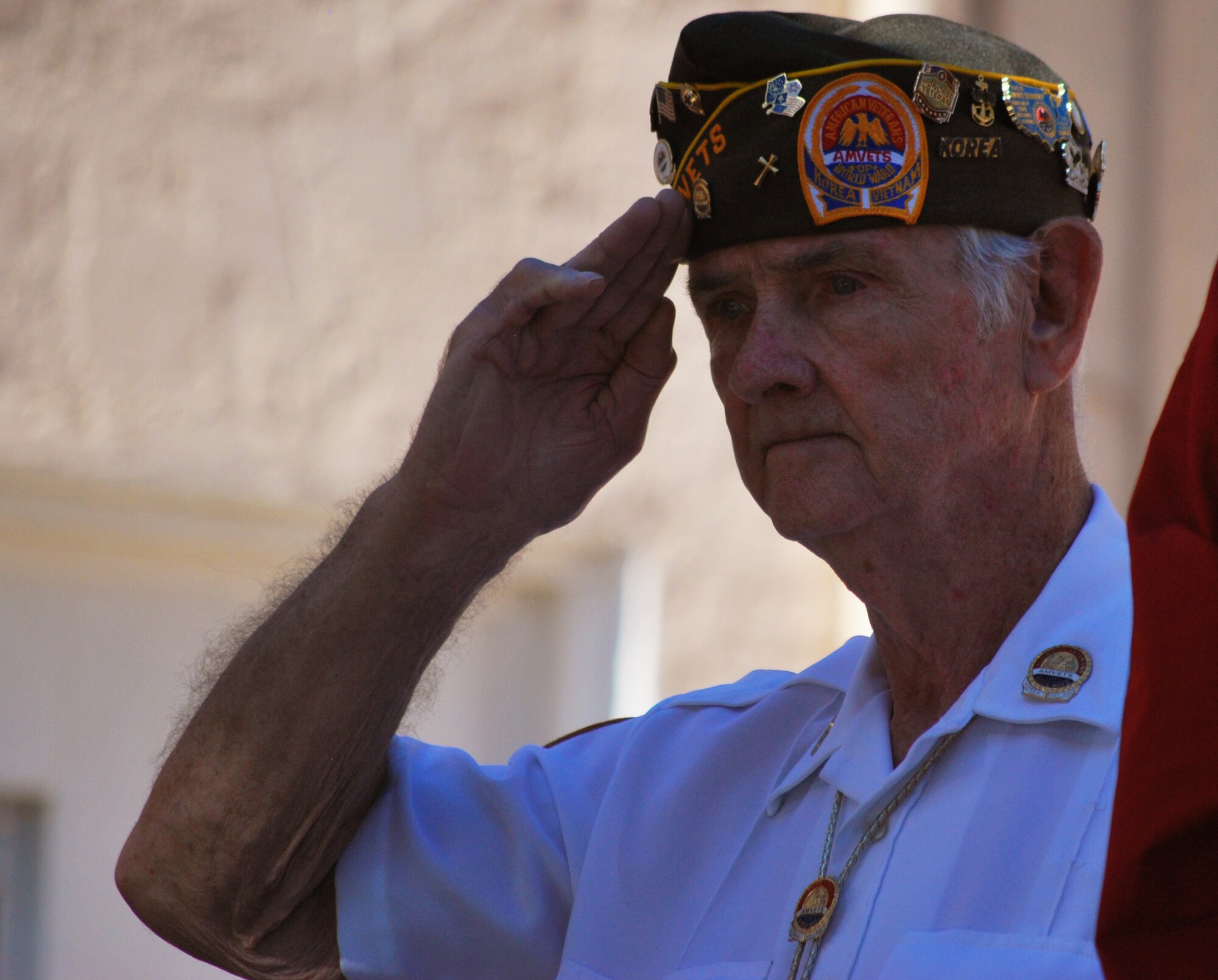 A veteran salutes the flag during the singing of the National Anthem at a Veteran’s Day ceremony at the Panama City Rescue Mission Nov. 11. The event provided free meals to homeless veterans.