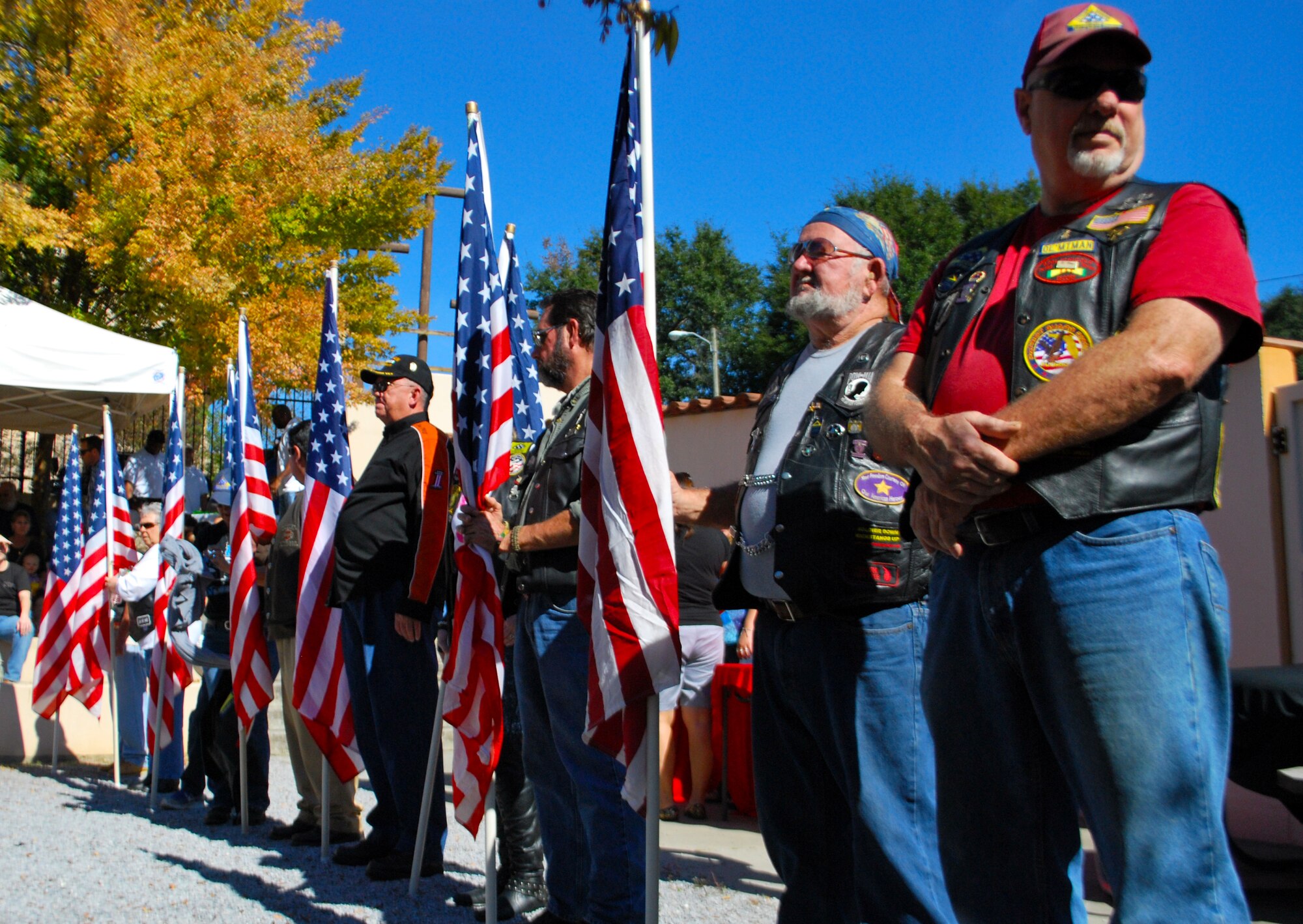 A group of motorcycle riders stand proudly during a ceremony honoring veterans at the Panama City Rescue Mission Nov. 11. The event provided free meals to homeless veterans.