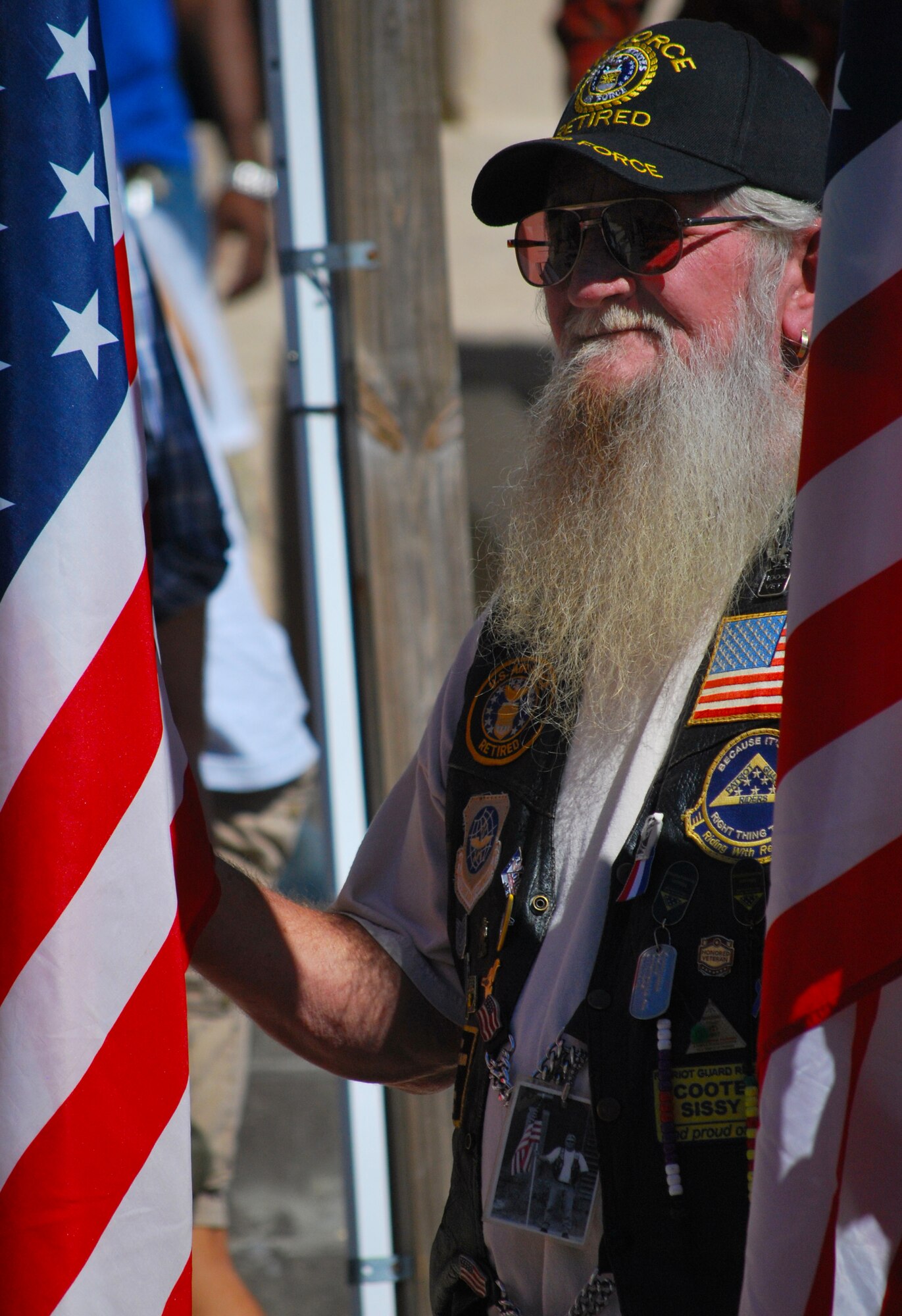 A motorcycle rider stands proudly honoring veterans during a Veteran’s Day ceremony at the Panama City Rescue Mission Nov. 11. The event provided free meals to homeless veterans.