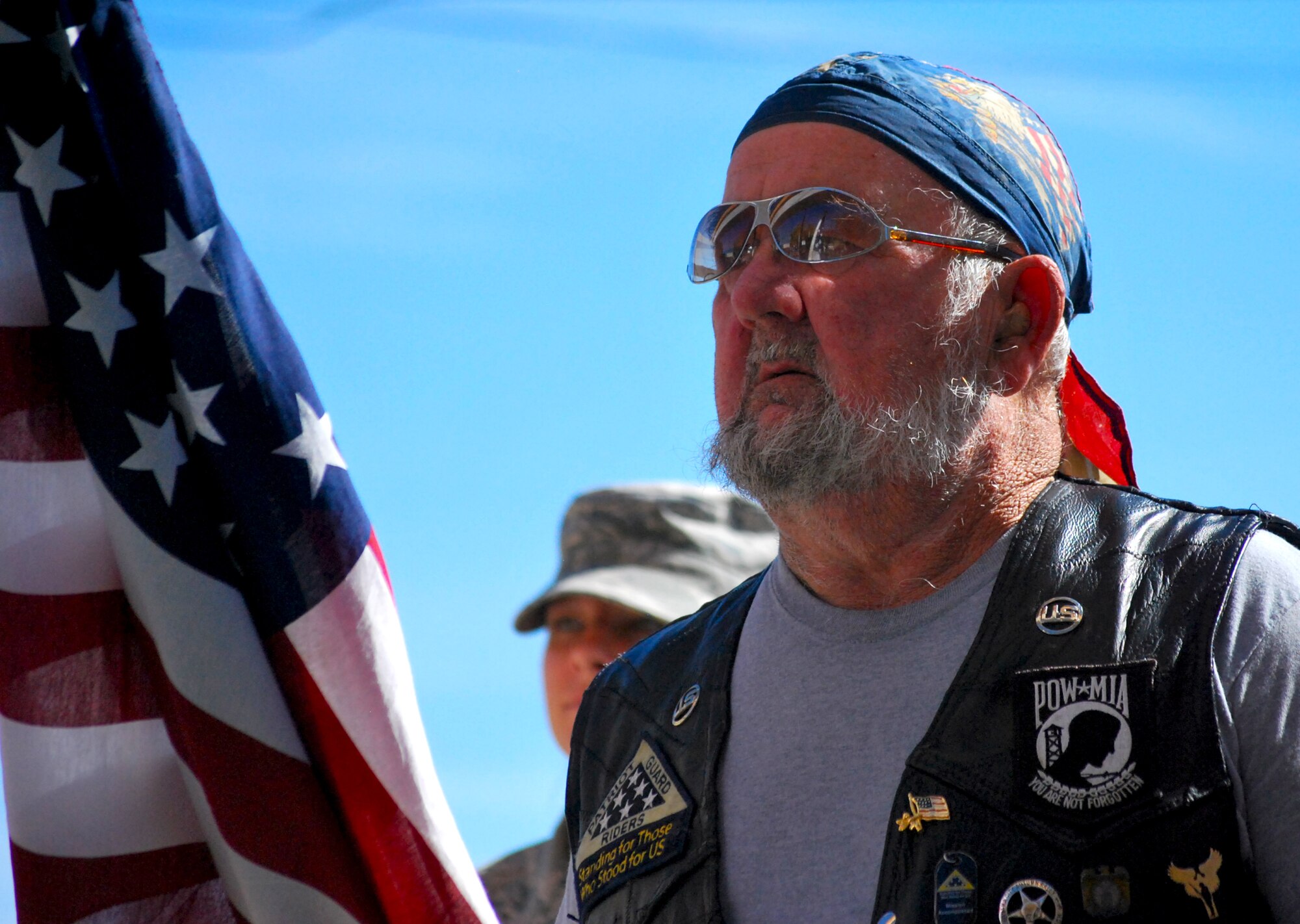 A motorcycle rider stands proudly honoring veterans during a Veteran’s Day ceremony at the Panama City Rescue Mission Nov. 11. The event provided free meals to homeless veterans.