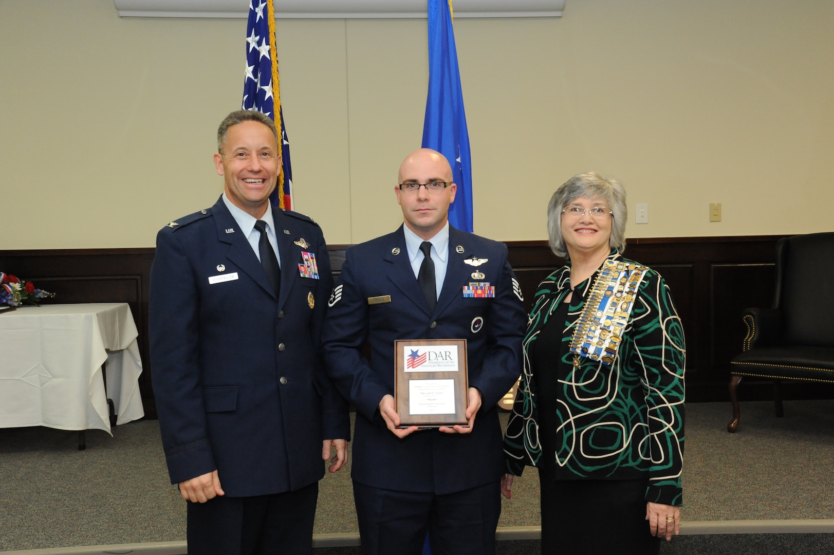 Col. Gerald Goodfellow, 12 Flying Training Wing commander, Joint Base San Antonio-Randolph, and Mrs. Susan Green Tillman, State Recording Secretary of Texas, Daughters of the American Revolution, present Staff Sgt. Judd* (*Editor's note: for security reasons, some personnel are referred to by their first names*) with the Remotely Piloted Aircraft Instructor of the Year Award. (U.S. Air Force Photo by Rich McFadden)