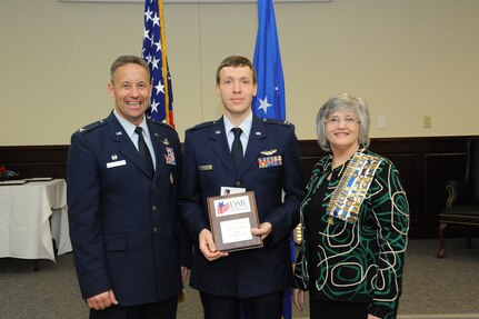 Col. Gerald Goodfellow, 12 Flying Training Wing commander, Joint Base San Antonio-Randolph, and Mrs. Susan Green Tillman, State Recording Secretary of Texas, Daughters of the American Revolution, present Capt. Brian Thalhofer with the Instructor Pilot of the Year Award. (U.S. Air Force Photo by Rich McFadden)